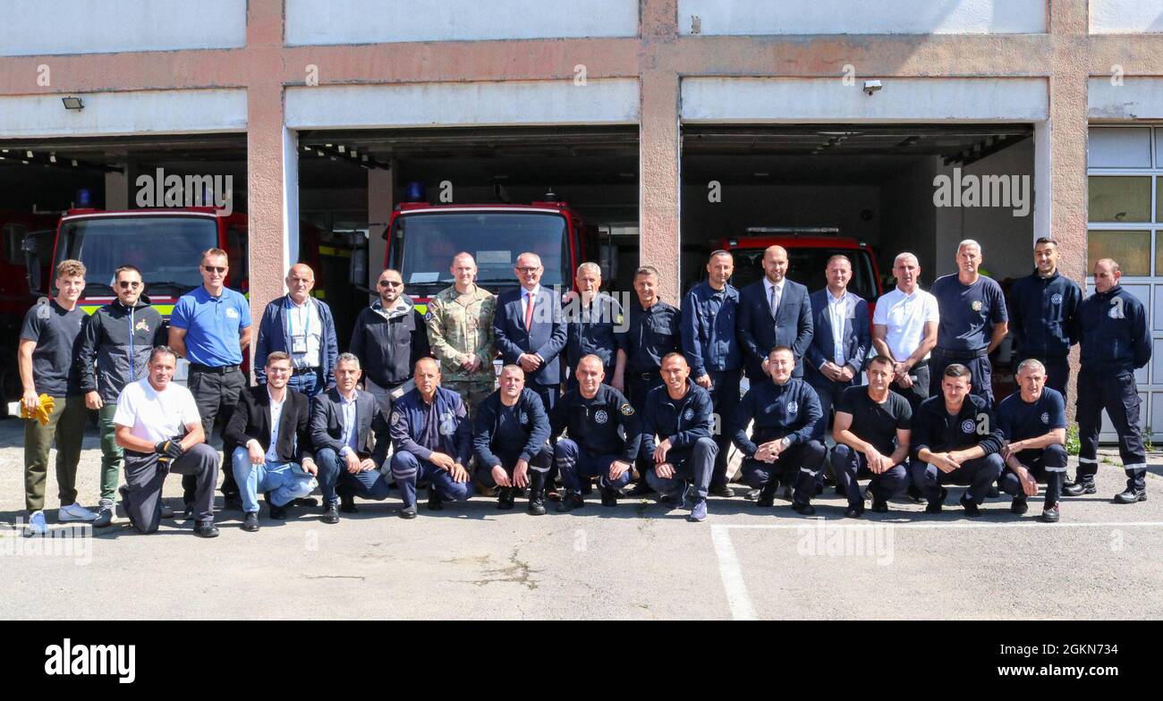 1st Lt. Jacob Bruggeman, officer in charge of the Kilo 21 Liaison Monitoring Team, Regional Command-East, Kosovo Force, poses for a photo with members of the Camp Bondsteel and Ferizaj/Urosevac Fire Departments and key community leaders in Kosovo, on June 3, 2021. The Camp Bondsteel Fire Department and Kilo 21 worked together to donate 140 sections of hoses to the municipality’s only firefighting team. Stock Photo