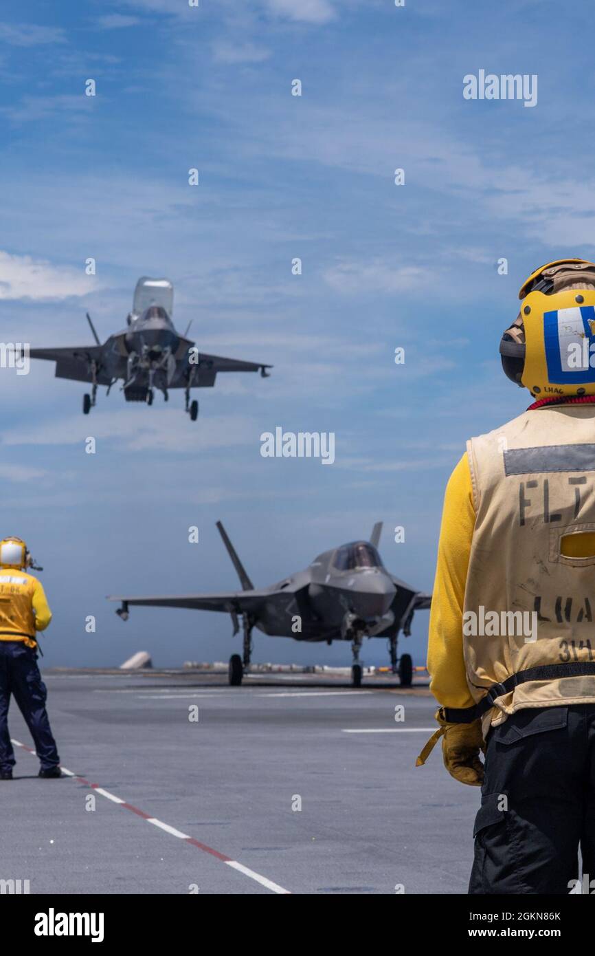 PHILIPPINE SEA (June 3, 2021) Sailors assigned to the forward-deployed amphibious assault ship USS America (LHA 6) conduct flight operations with F-35B Lightning aircraft from the 31st Marine Expeditionary Unit. America, lead ship of the America Amphibious Ready Group, is operating in the U.S. 7th Fleet area of operations to enhance interoperability with allies and partners and serve as a ready response force to defend peace and stability in the Indo-Pacific region. Stock Photo