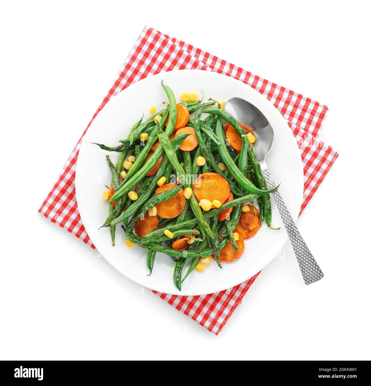Plate with delicious green beans, corn and carrot slices on white