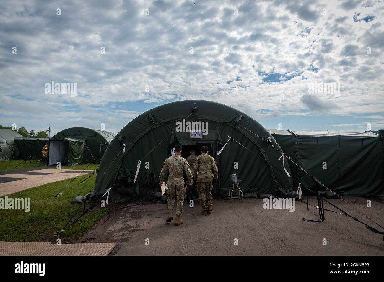 U.S. Soldiers with 30th Medical Brigade transport a simulated casualty to a role 3 care facility during Hospital Exercise 21 at Baumholder, Germany June 3, 2021. The 30th MED BDE deployed over 400 Soldiers in support of Hospital Exercise 21 which served to certify the 519th Hospital center as a NATO role 2 enhanced capability. The 30th MED BDE treated over 100 simulated patients from the point of injury to medical evacuation to higher echelons of care. The exercise also enhanced joint, combine and multi echelon interoperability. Stock Photo