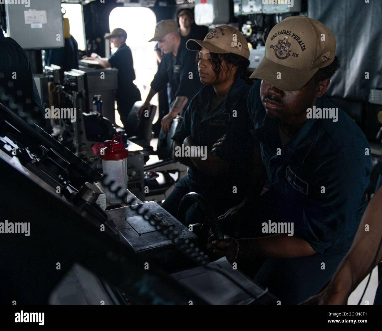 210603-N-HG846-1062 SEA OF JAPAN (June 3, 2021) – Retail Specialist Seaman Alescia Pugh (left), from Schenectady, N.Y., and Seaman Dravian Marbury, from Atlanta, Ga., man the lee helm and helm in the pilot house aboard Arleigh Burke-class guided-missile destroyer USS Rafael Peralta (DDG 115). Rafael Peralta is assigned to Commander, Task Force 71/Destroyer Squadron (DESRON) 15, the Navy's largest forward-deployed DESRON and U.S. 7th Fleet's principal surface force. Stock Photo