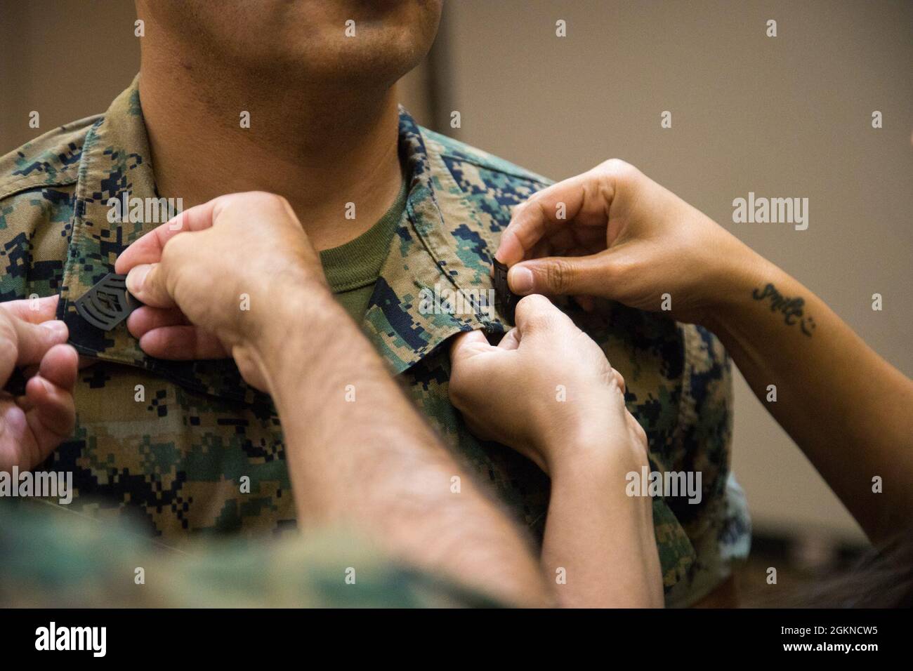 U.S. Marine Corps Master Sgt. James McFaline is pinned during his