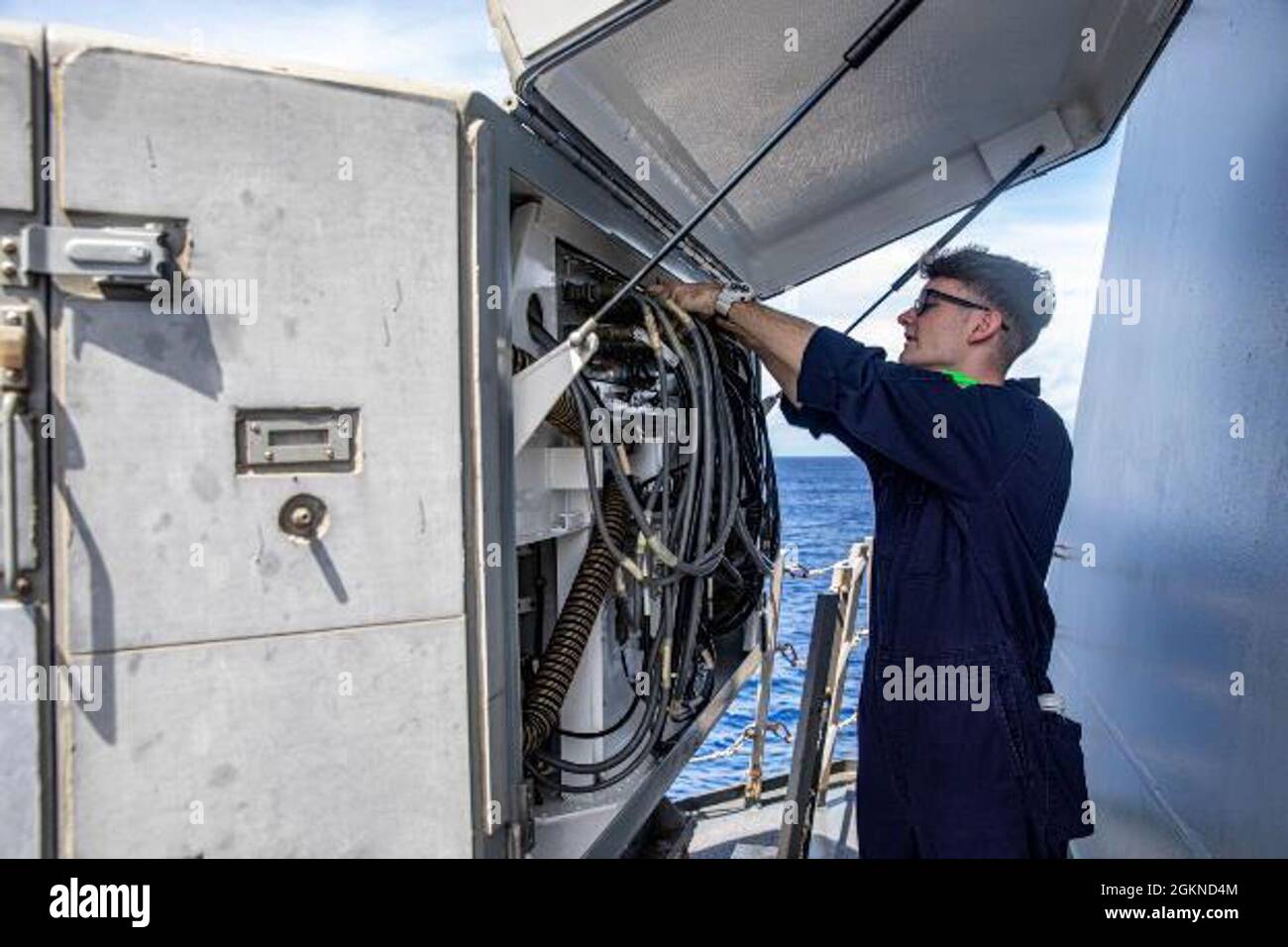 PACIFIC OCEAN (June 4, 2021) – Cryptologic Technician Technical 2nd Class Ryan Smith, from Cave Creek, Ariz., conducts maintenance on an SLQ-32 electronic warfare suite aboard the Arleigh Burke-class guided-missile destroyer USS Halsey (DDG 97). Halsey is attached to Commander, Task Force 70/Carrier Strike Group 5 conducting underway operations in support of a free and open Indo-Pacific. Stock Photo