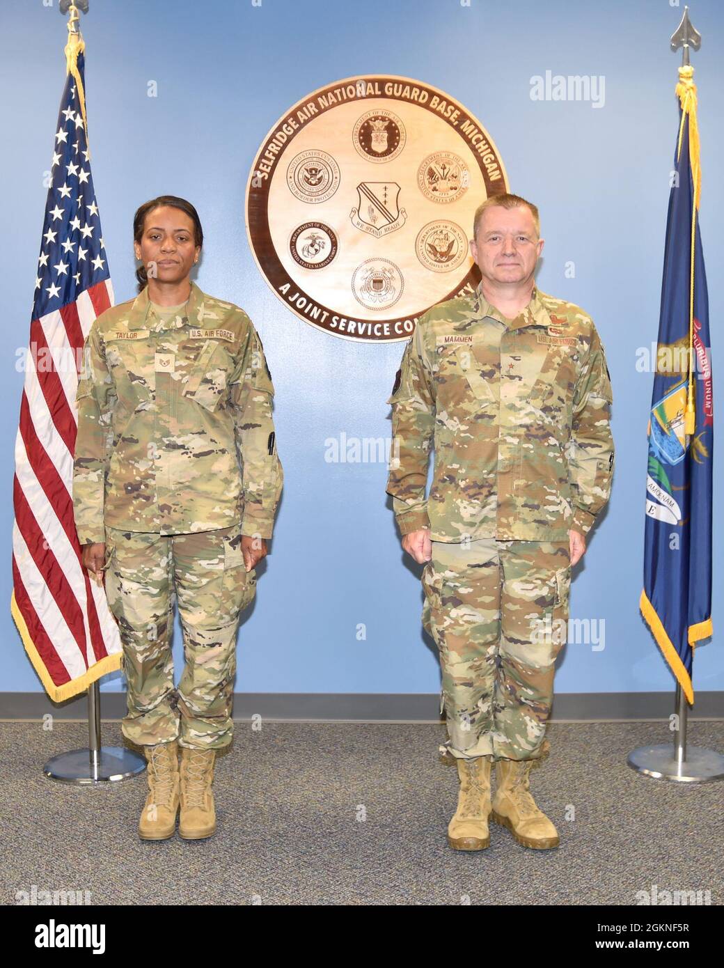 SELFRIDGE AIR NATIONAL GUARD, Mich.-- Tech. Sgt. Samara Taylor, a public affairs specialist with the 127th Wing Public Affairs office here, and Brig. Gen. Rolf E. Mammen, commander 127th Wing, stand at attention in advance of Taylor's promotion to the rank of technical sergeant here on June 5, 2021. Stock Photo
