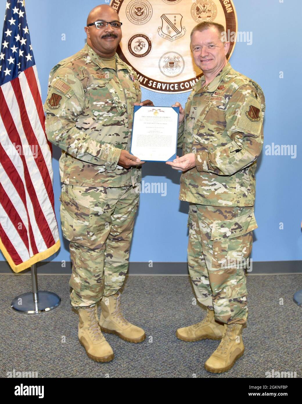 SELFRIDGE AIR NATIONAL GUARD BASE, Mich.— Sr. Master Sgt. Maurice Graves, 127th Wing human resource advisor here,  is awarded the Meritorious Service Medal by Brig. Gen. Rolf E. Mammen, 127th Wing commander here, on June 5, 2021. Stock Photo
