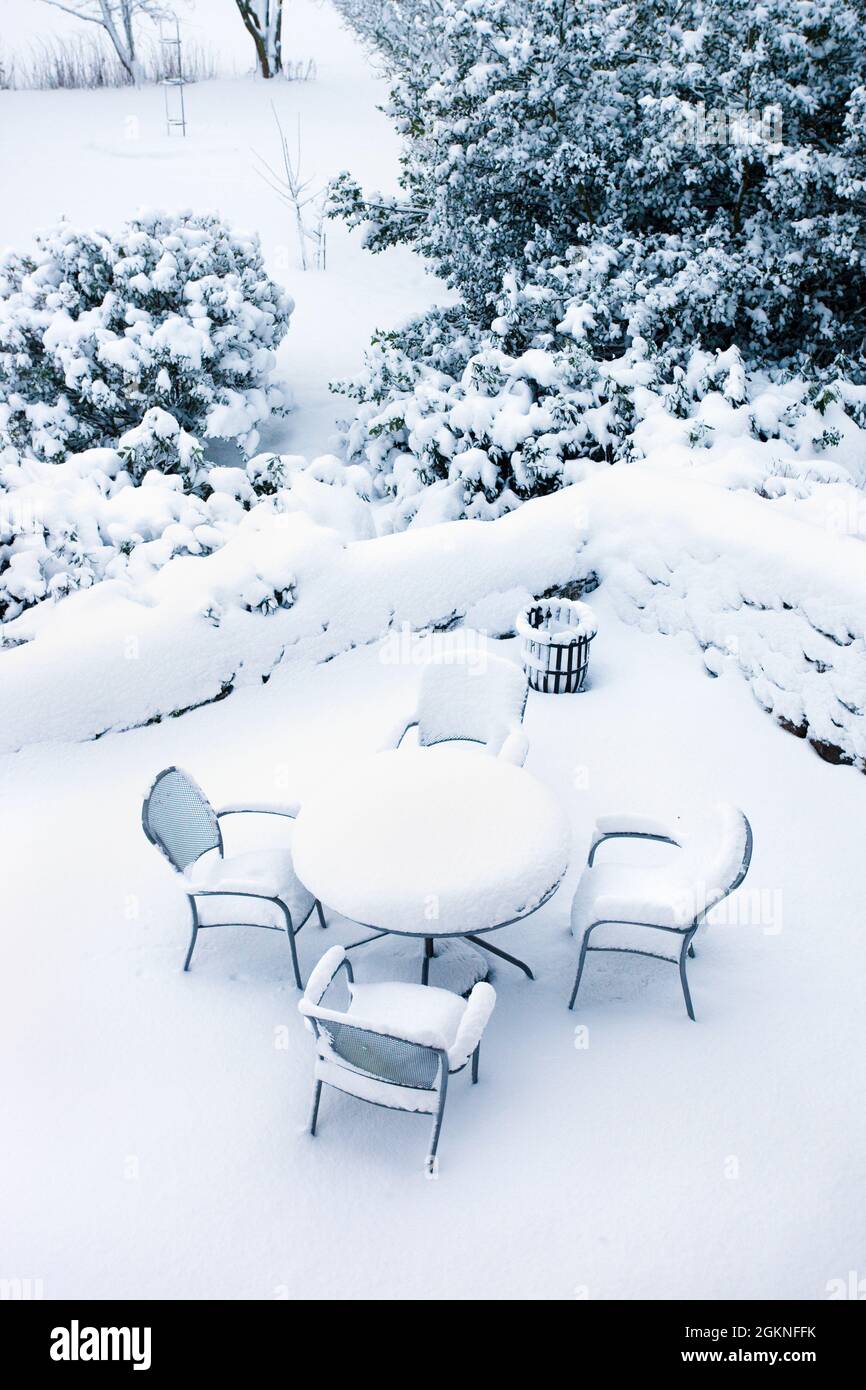 Garden snowscape, snow on picnic table, winter in UK Stock Photo