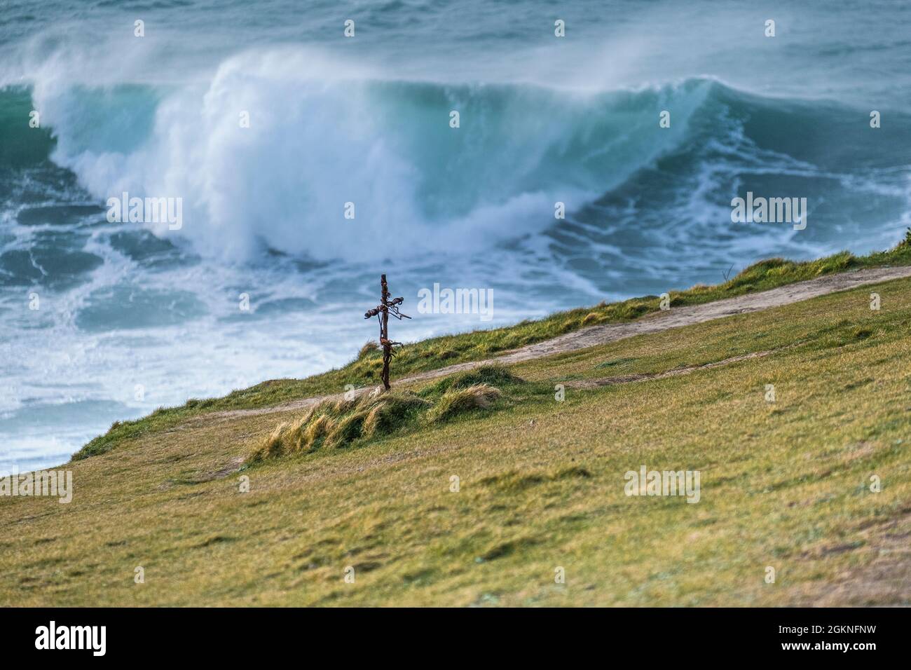 A small iron memorial cross on Towan Head overlooking the sea in Newquay in Cornwall. Stock Photo
