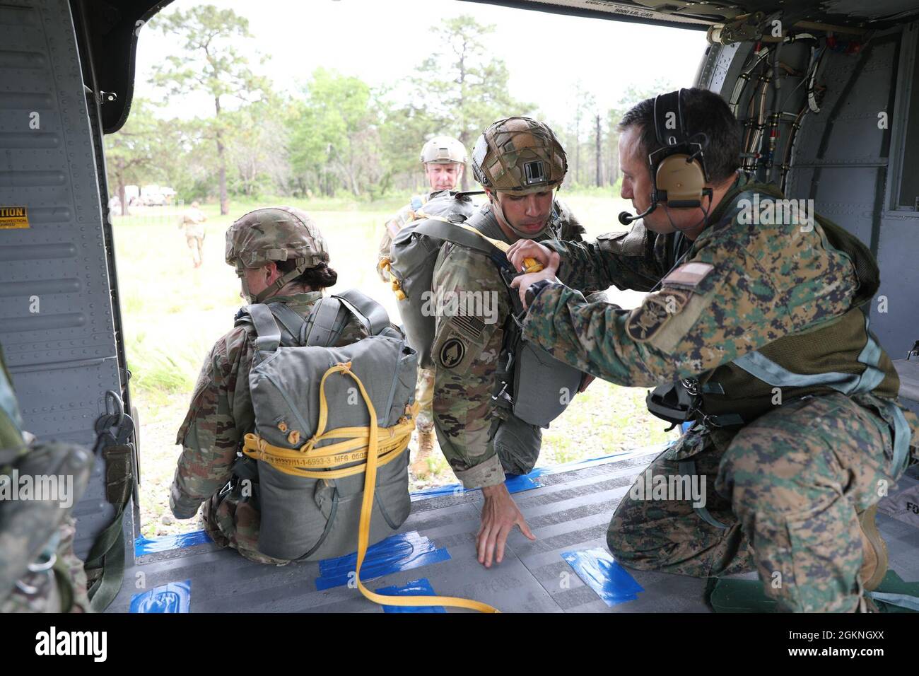 U.S. Army Reserve paratroopers prepare for nontactical airborne operations, June 5, 2021, at Saint Mere Eglise drop zone, Fort Bragg, N.C. USACAPOC(A) jumpmasters worked with Capt. Ignacio Rios, a Chilean jumpmaster assigned to the 1st Special Warfare Training Group(A), U.S. Army John F. Kennedy Special Warfare Center and School Stock Photo