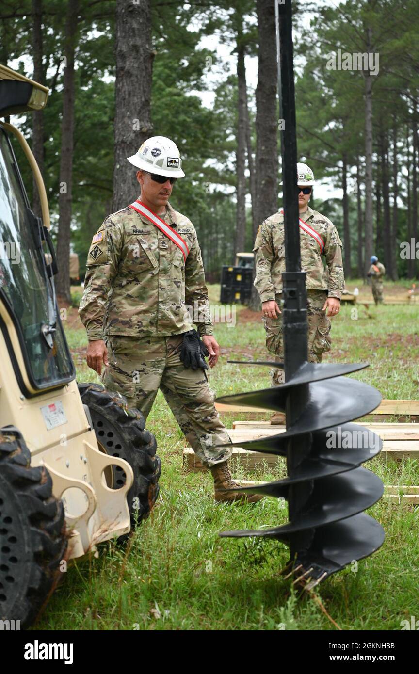 U.S. Army National Guard Soldiers with the 1223rd Vertical Engineering Company, South Carolina National Guard, build an air assault obstacle course June 6, 2021, at McCrady Training Center, Eastover, South Carolina. The course is intended for future training operations that will take place at the training center. Stock Photo