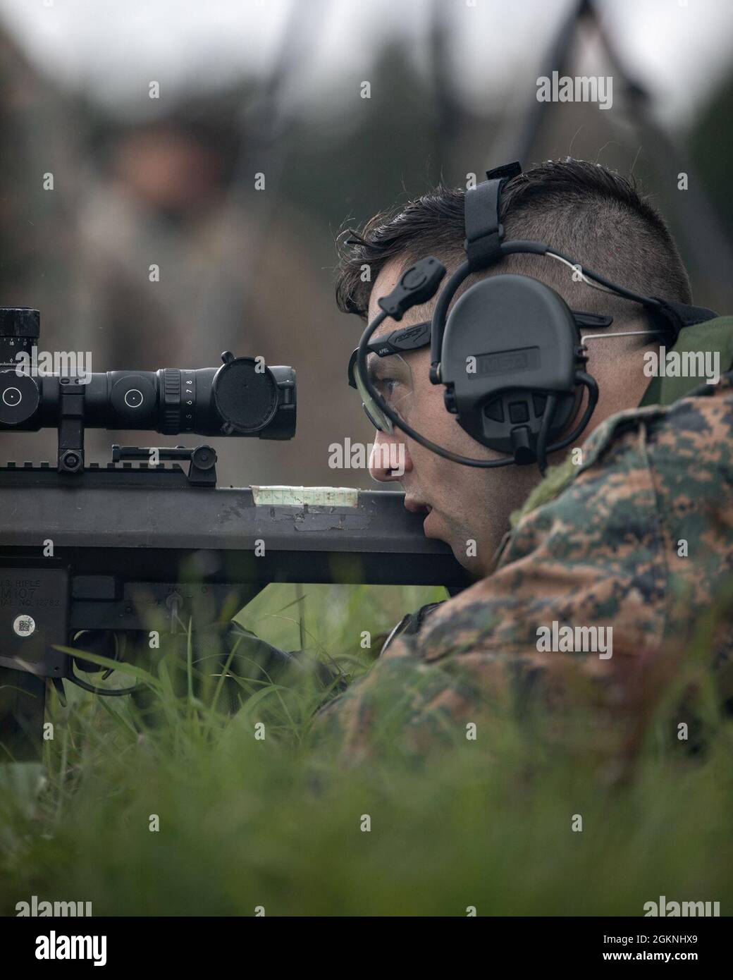 A Marine with 3rd Force Reconnaissance Company, 4th Marine Division, aims down range during sniper training at Camp Shelby, Mississippi, on June 6, 2021. The Marines trained with the M107 semi-automatic long-range sniper rifle, an anti-materiel rifle that fires .50 caliber ammunition out to a maximum effective range of 2000 meters. Stock Photo