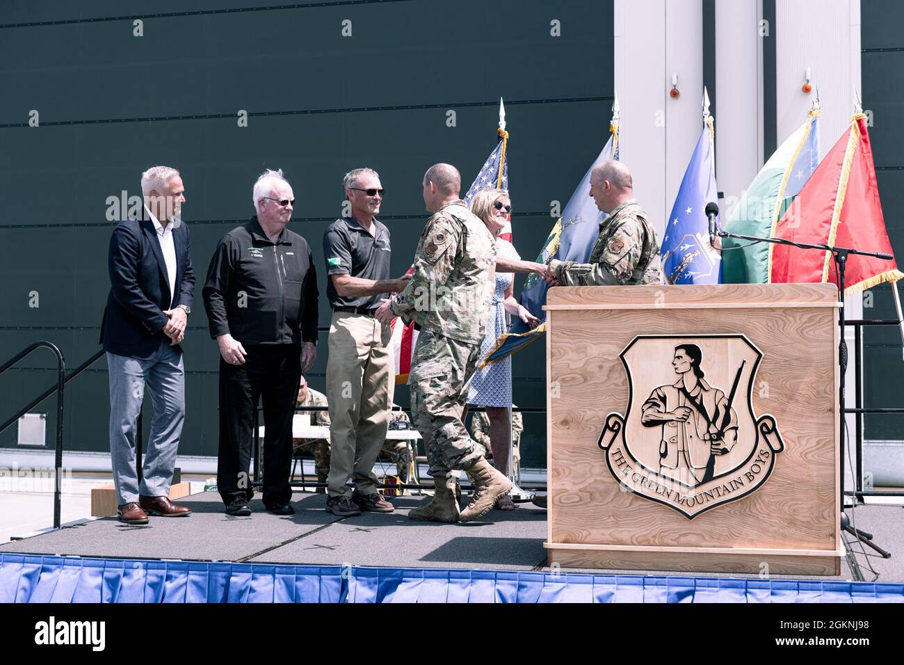 Retired Air Force Col. Phil Murdock, former commander of the 158th Fighter Wing, Vermont Air National Guard, and his wife Helen, receive the True North Award from wing leadership during the 75th annviersary ceremony, South Burlington Air National Guard Base, South Burlington, Vt., June 6, 2021. The Vermont National Guard held a ceremony on base to mark 75 years of flying operations since August 1946 when the 134th Fighter Squadron was the fifth flying squadron formed in the National Guard which saw Murdock, commander during the first decade of the 2000s, and his wife get the award for fosterin Stock Photo