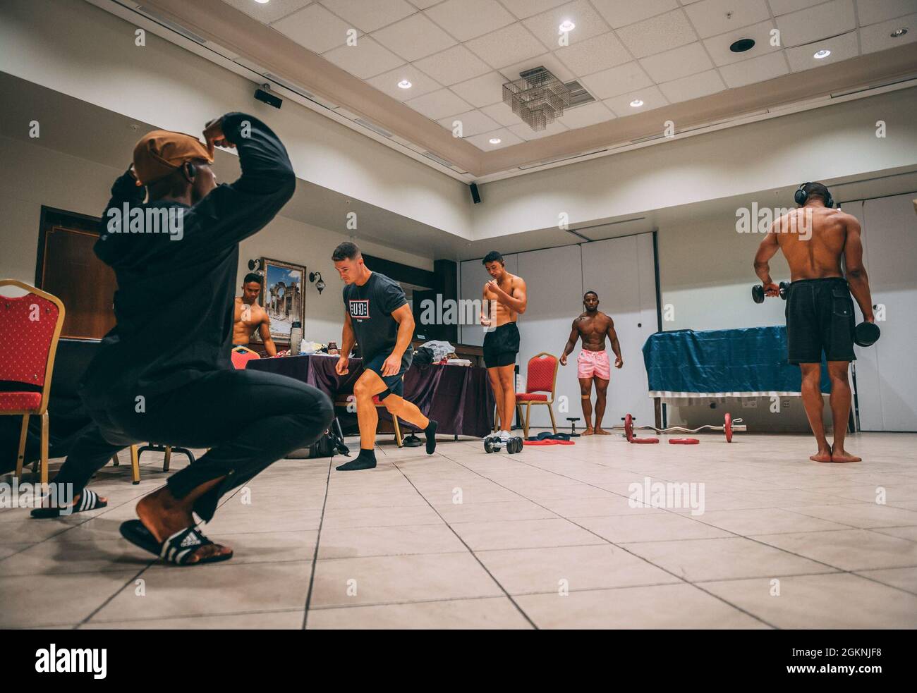Airmen from the 39th Air Base Wing warm up back stage during the Clash of the Titans bodybuilding competition, June 6, 2021, at Incirlik Air Base, Turkey. Five male and female participants competed for first, second, and third place titles in the bikini, classic and physique divisions. Stock Photo