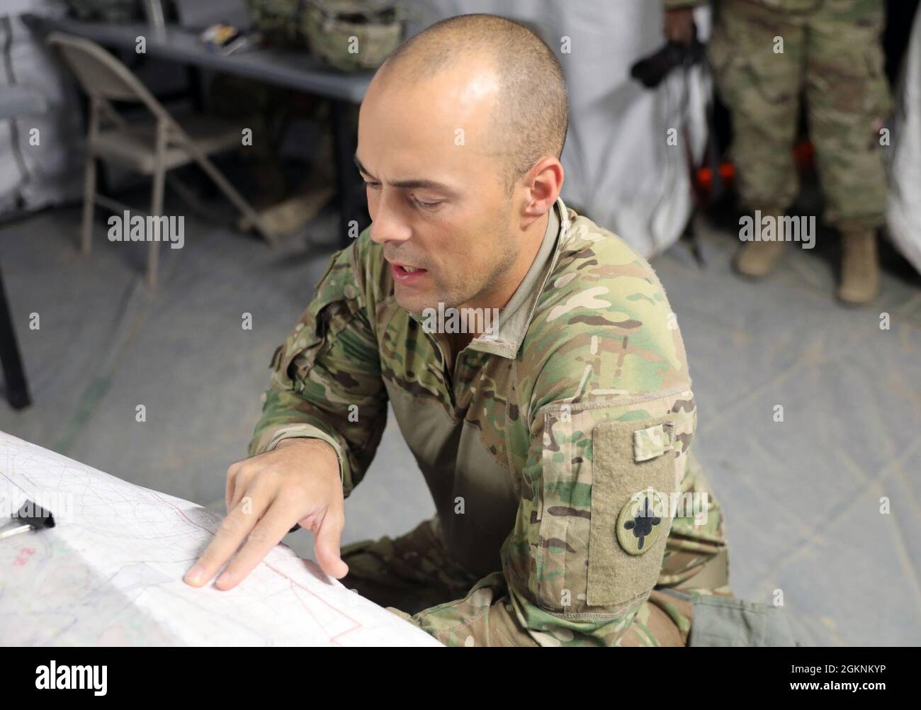 Capt. Robert Goodson with the 298th Support Battalion, Mississippi Army National Guard, discusses tactical operations at the National Training Center, Fort Irwin, California, June 7, 2021. The 298th SPT BN is training as a part of the 155th Armored Brigade Combat Team, currently completing their rotation at NTC. Stock Photo