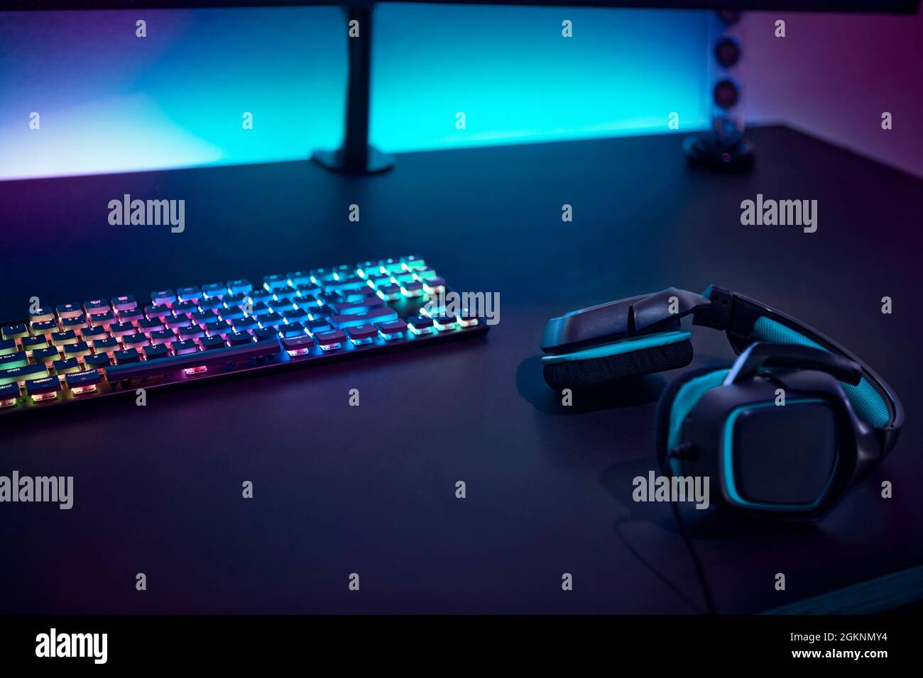 Gaming accessories on dark table. Keyboard with color backlit and