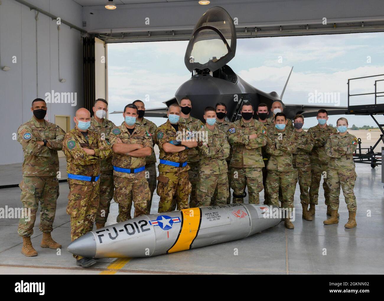 U.S. Air Force Airmen and Italian air force pose for a photo in front ...