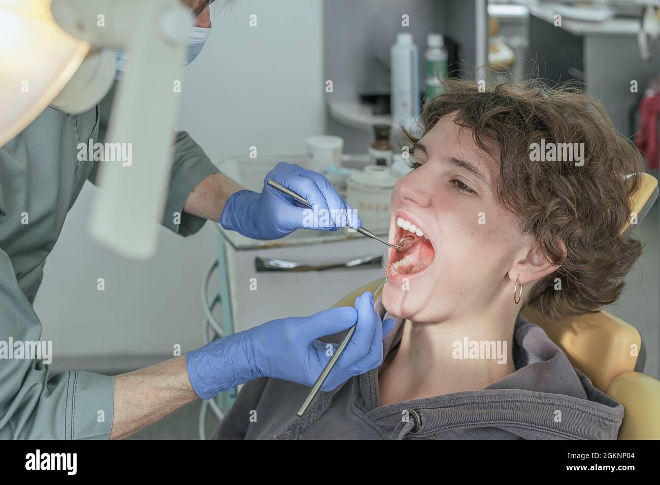 Dentist doctor examines the health of teeth of teenage girl in dental office Stock Photo