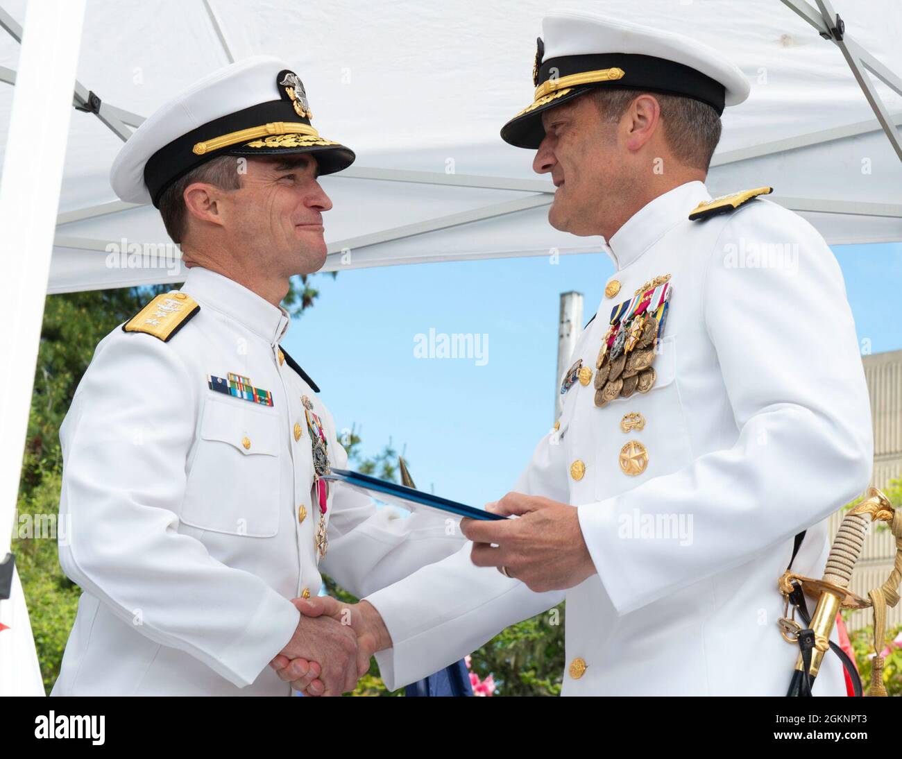 SILVERDALE, Wash. - Rear Adm. Douglas Perry, left, receives the Legion of Merit from Rear Adm. Jeffrey Jablon, right, during the Commander, Submarine Group 9 Change of Command ceremony held at Deterrent Park, Naval Base Kitsap-Bangor, June 8. Subordinate to Commander, Submarine Force, U.S. Pacific Fleet, COMSUBGRU- 9 exercises administrative, tactical and operational command and control authority for assigned Trident fleet ballistic and cruise missile submarines and subordinate commands and units in the Pacific Northwest. Subordinate commands include Submarine Squadrons 17 and 19, and Naval Su Stock Photo