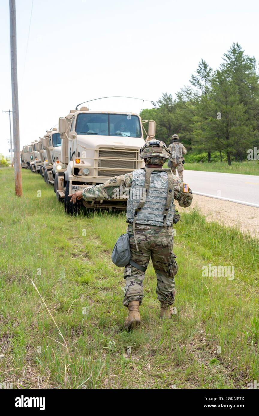 Sgt. Cordney Easley, a motor transport operator with the 206th Transportation Company, 207th Regional Support Group, 377th Theater Sustainment Command, ground guides an M915A5 Line-Haul Tractor Truck from a ditch on the side of a road June 8, 2021, on Fort McCoy, Wis. The vehicles needed to be safely driven out of the ditch without compromising each truck’s tipping point angle. Stock Photo