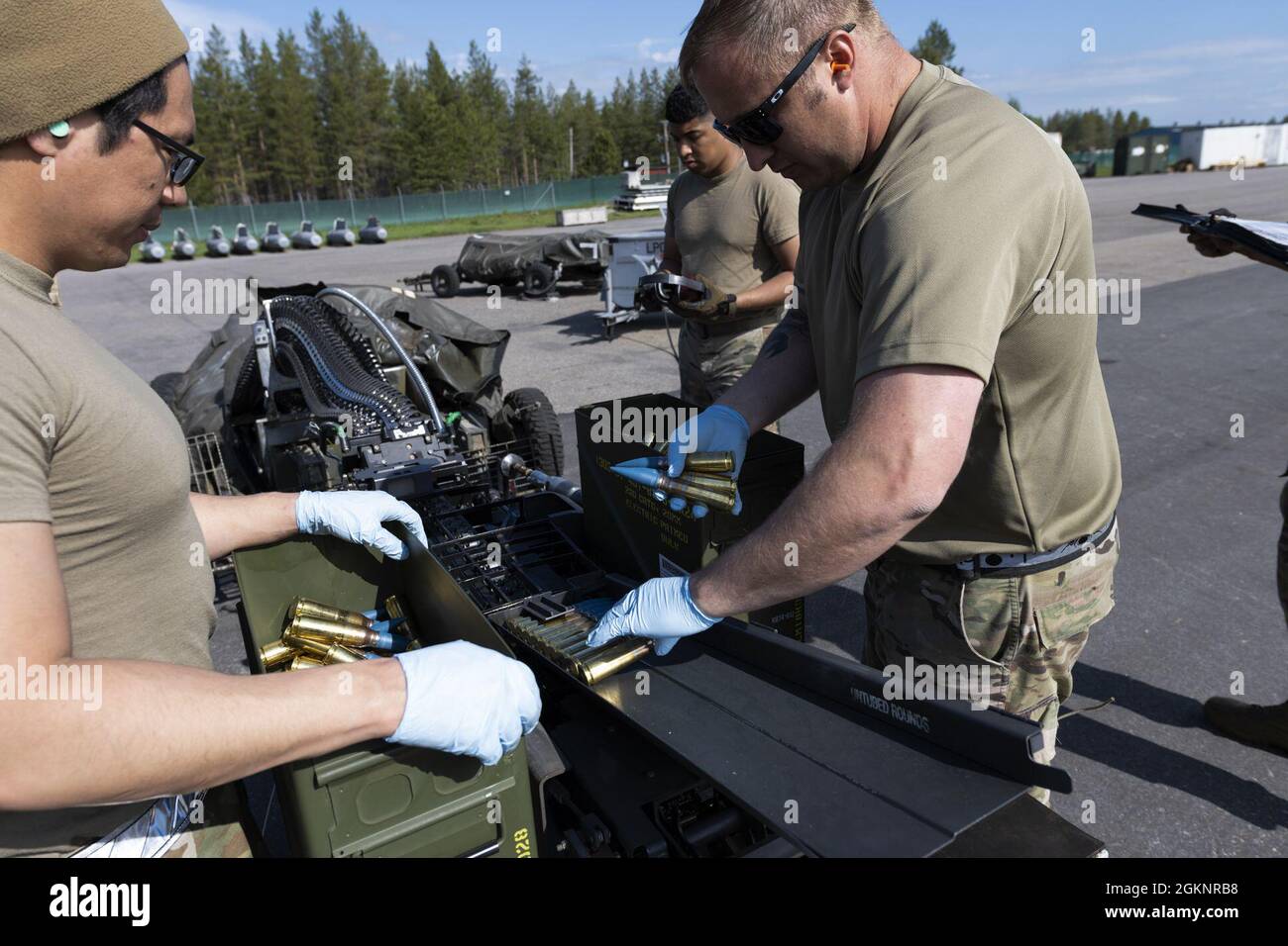 U.S. Air Force Airmen from the 52nd Maintenance Squadron at Spangdahlem Air Base, Germany, use a replenisher table equipped with a universal ammunition reloader at Kallax Air Base, Sweden, June 8, 2021. The UAL is a streamlined way to reload the weapons system of F-16 aircraft, which in this instance is loaded with rubber tipped bullets for training purposes during the Arctic Challenge Exercise 2021. Stock Photo