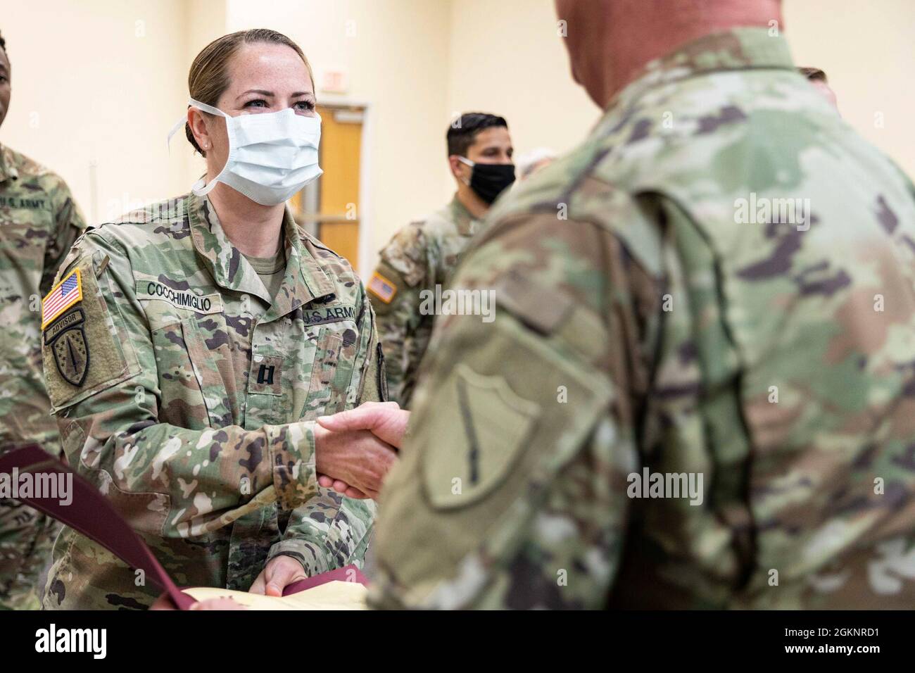 U.S. Army Brig. Gen. Robert J. Larkin, adjutant general of the Kentucky National Guard, presents a Kentucky Commendation Medal to U.S. Army Capt. Stefanie Cocchimiglio, a registered nurse at the Community Vaccination Center at the Henderson County Cooperative Extension Service in Henderson, Kentucky, June 8, 2021. U.S. Northern Command, through U.S. Army North, remains committed to providing continued, flexible Department of Defense Support to the Federal Emergency Management Agency as part of the whole-of-government response to COVID-19. Stock Photo