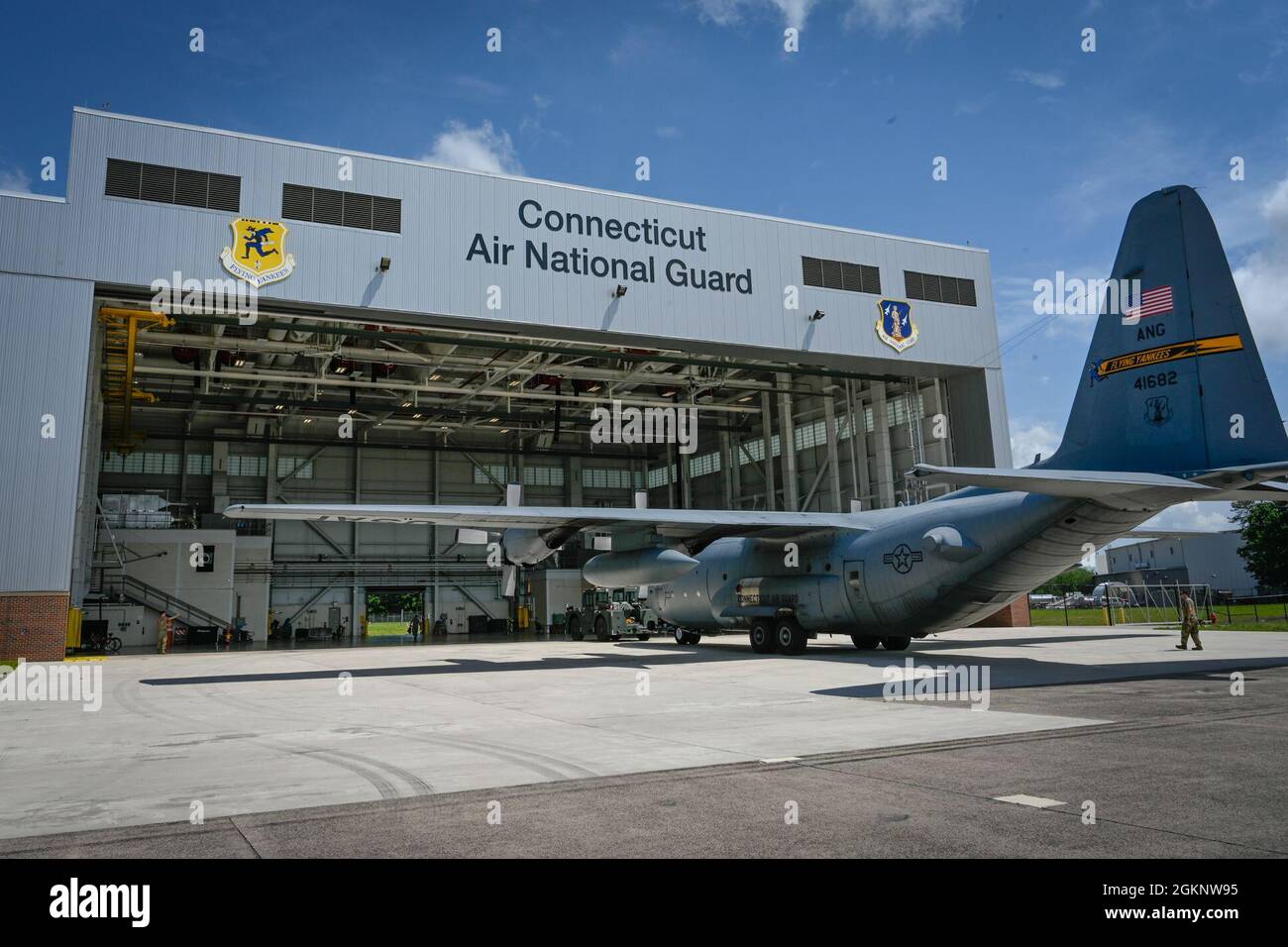 Airmen from the 103rd Maintenance Group tow a C130H Hercules aircraft