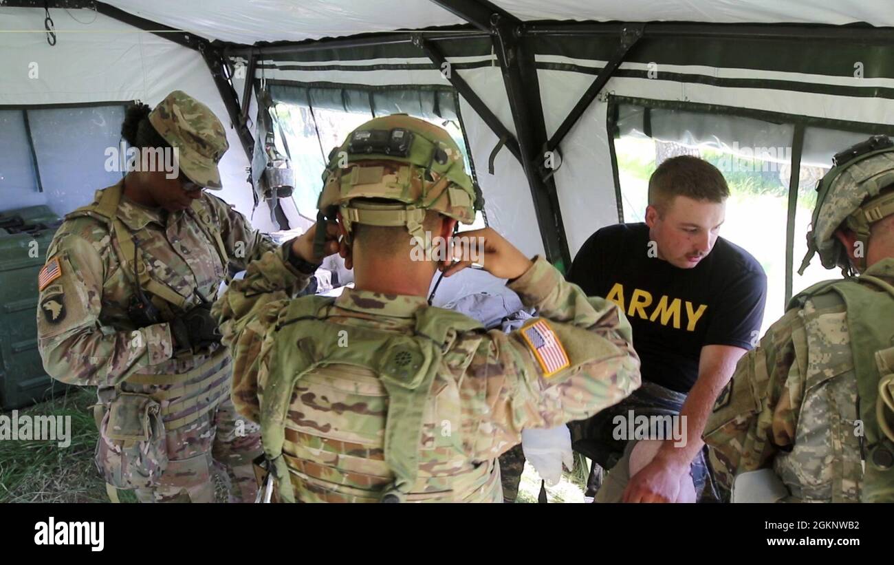 U.S. Army Sgt. 1st Class Fallicia Keith, a medic assigned to 2nd Battalion, 307th Infantry Regiment, 157th Infantry Brigade, 1st Army Division East observes 2nd Battalion, 130th Field Artillery medics performing casualty treatment procedures during XCTC 21-05 at the Camp Guernsey Joint Training Center, Wyoming, June 8, 2021. Observer, Coach/Trainers from 157th IN BDE provided feedback at each stage of XCTC to help training units develop and improve their capabilities. Stock Photo