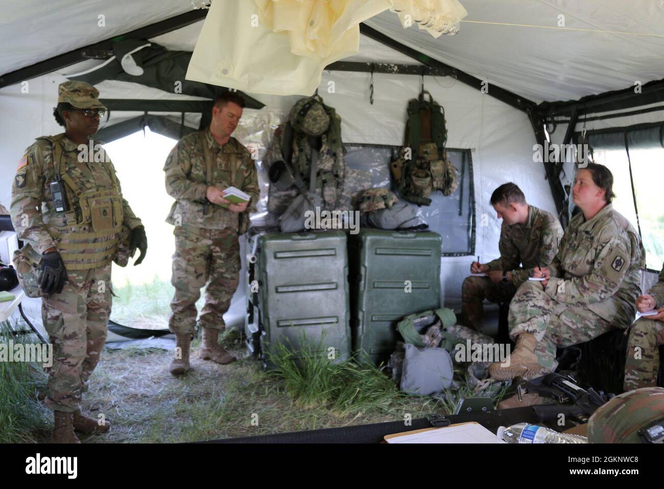 U.S. Army Sgt. 1st Class Fallicia Keith, a medic assigned to 2nd Battalion, 307th Infantry Regiment, 157th Infantry Brigade, leads an after action review for 2nd Battalion, 130th Field Artillery medics during XCTC 21-05 at the Camp Guernsey Joint Training Center, Wyoming, June 8, 2021. Keith highlighted the unit’s strengths and successes during a casualty treatment and evacuation scenario while allowing them to identify areas of improvement. Stock Photo