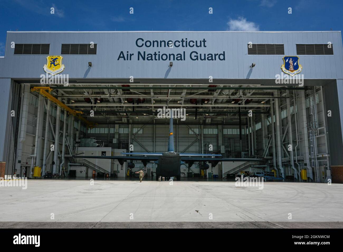 Airmen from the 103rd Maintenance Group tow a C130H Hercules aircraft