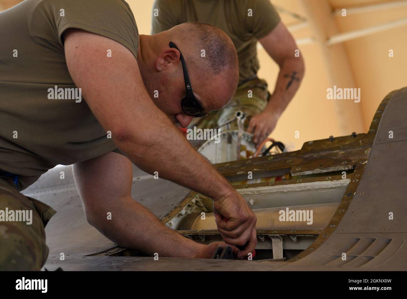 U.S. Air Force Master Sgt. James Laverdiere, 378th Expeditionary Maintenance Squadron armament backshop personnel, works to remove parts of an M61A1 Vulcan cannon from an F-16 Fighting Falcon fighter jet at Prince Sultan Air Base, Kingdom of Saudi Arabia, June 8, 2021. The 'Swamp Fox' Airmen from the South Carolina Air National Guard are deployed to PSAB to project combat power and help bolster defensive capabilities against potential threats in the region. Stock Photo