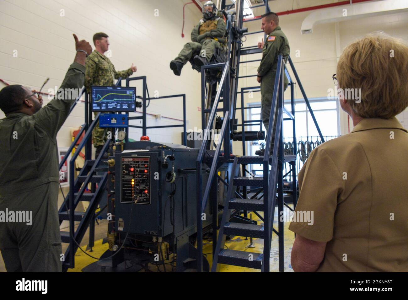 PENSACOLA, Fla. (June 9, 2021) Rear Adm. Cynthia Kuehner, Commander, Naval Medical Forces Support Command (NMFSC), observes an aircraft ejection seat trainer demonstration at the Aviation Survival Training Center (ASTC) Pensacola as a part of her visit to Navy Medicine Operational Training Command (NMOTC). The mission of NMOTC is to provide training for operational medicine and aviation survival. Support the Fleet and Fleet Marine Force with operational medicine consultative services, conduct education and training programs for medical department personnel in various operational medicine disci Stock Photo