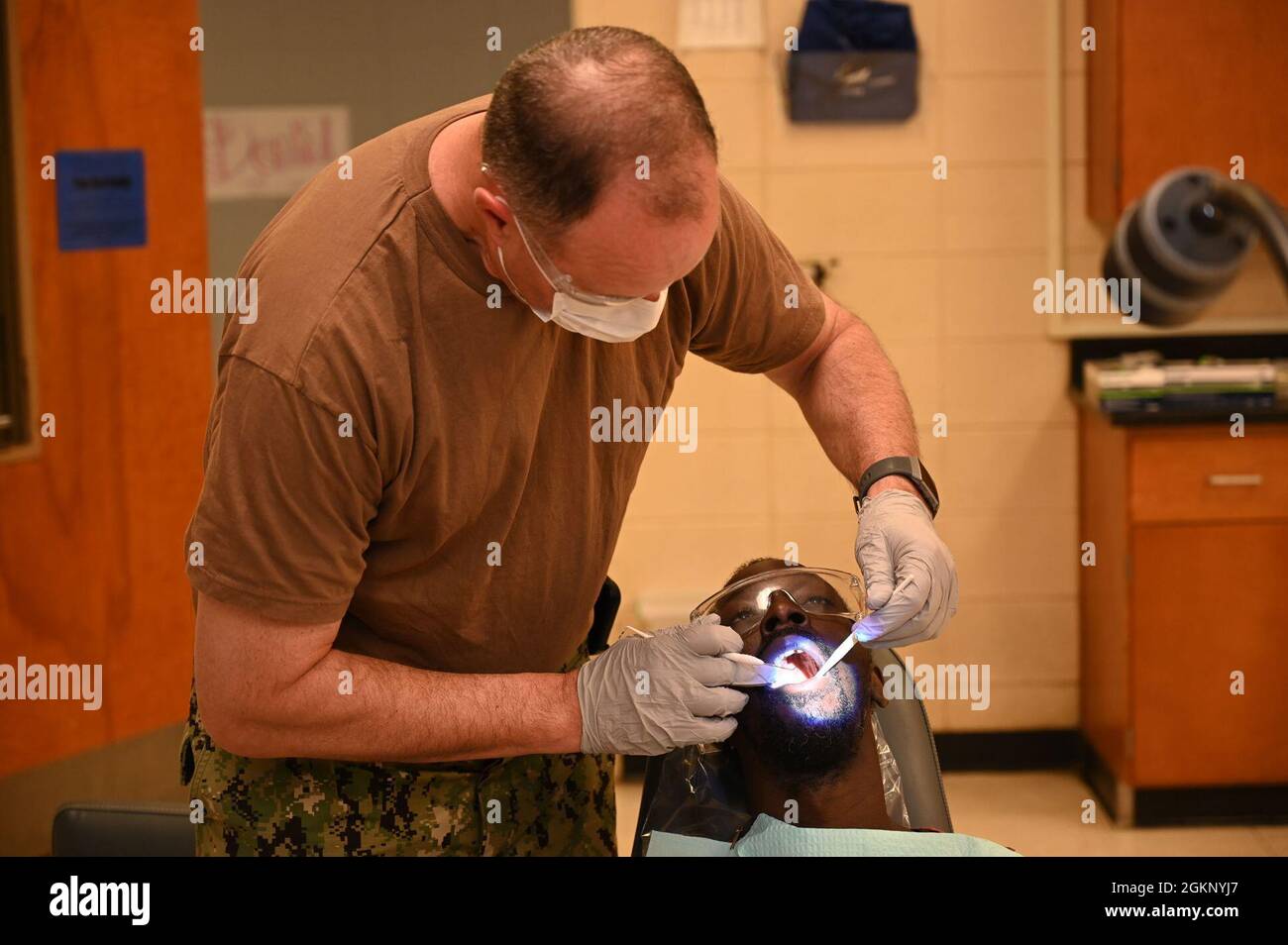 U.S. Air Force Lt. Col. Allen Barth, a dentist at the Innovative Readiness Training medical site in Waynesboro, Georgia, examines a patients mouth, June 9, 2021. The joint force exercise provides no-cost medical care to local residents. The training, with elements from the Army, Navy, Air Force and Marine Corps reserves, and the Air National Guard, runs from June 10-17, 2021, at four locations in East Central Georgia. Stock Photo