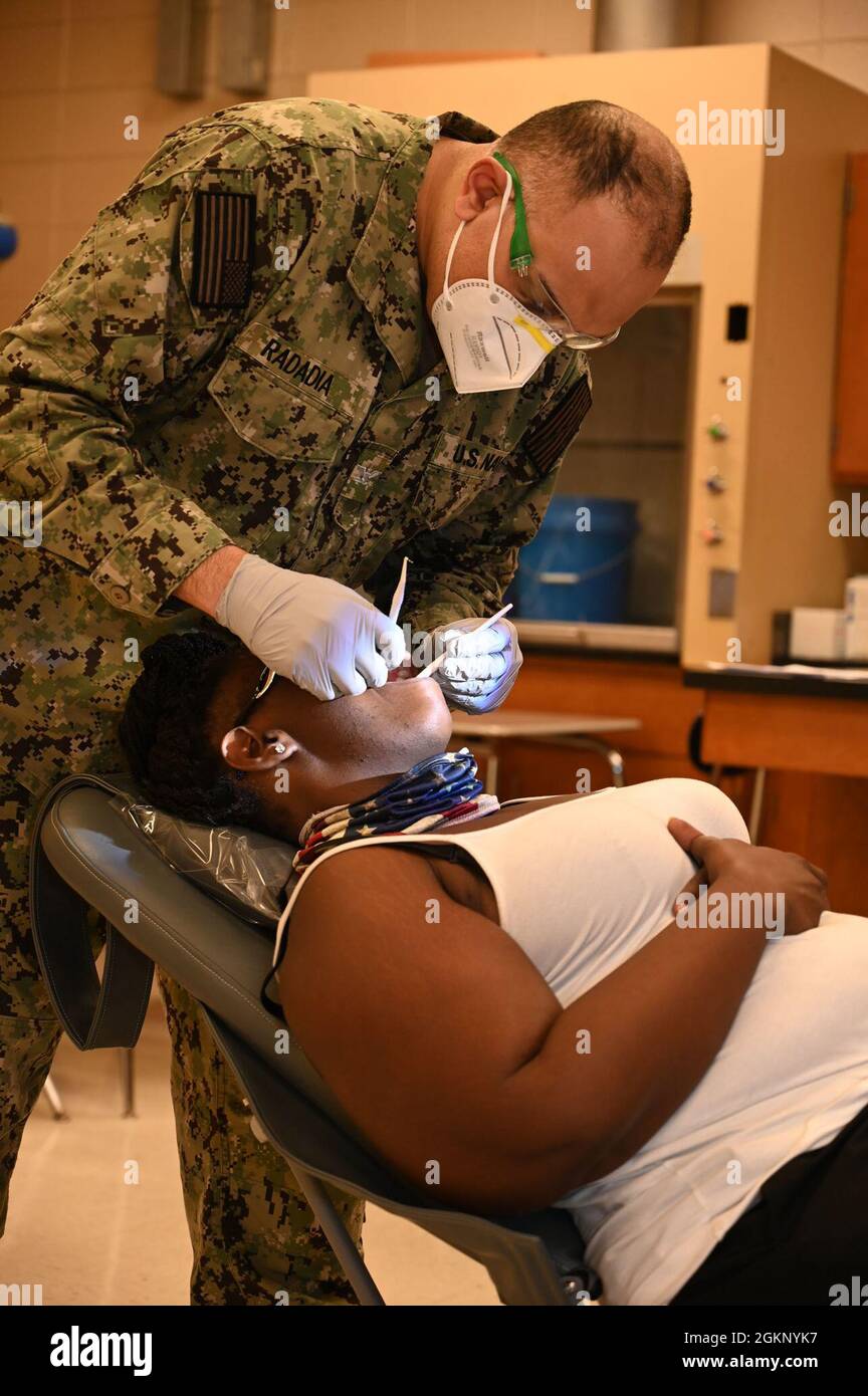 U.S. Navy Capt. Ritesh Radadia, a dentist at the Innovative Readiness Training medical site in Waynesboro, Georgia, examines a patients mouth, June 9, 2021. The joint force exercise provides no-cost medical care to local residents. The training, with elements from the Army, Navy, Air Force and Marine Corps reserves, and the Air National Guard, runs from June 10-17, 2021, at four locations in East Central Georgia. Stock Photo