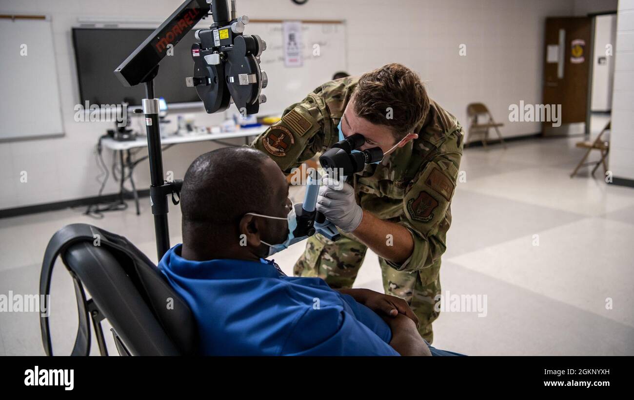 WAYNESBORO, Georgia – Capt. Adam Fannin, 445th Aerospace Medicine Squadron optometrist, assesses a patient at Jenkins County High School, Ga as part of East Central Georgia Medical Innovative Readiness Training on June 9, 2021. The IRT is a mission to provide no-cost health services from June 10 until June 17 and provides opportunities for military medical, engineering, and support personnel to receive training while making an impact in local communities throughout the United States. The mission was calculated to be worth $858,869 in fair market medical value with 30,587 procedures performed f Stock Photo