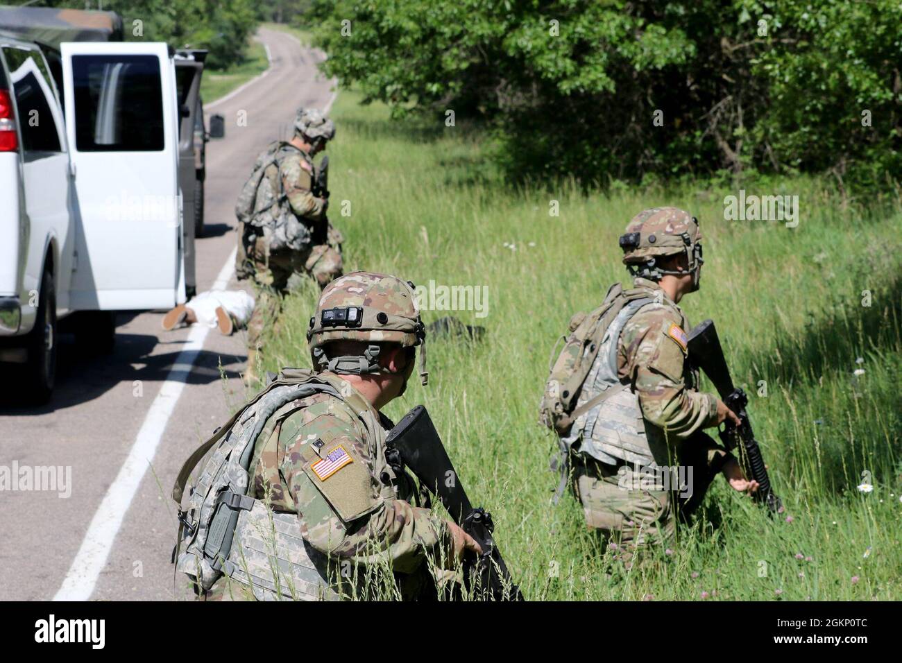 U.S. Army Reserve Soldiers provide security for medics during a simulated car accident during their annual training at Warrior Exercise 86-21-02 on Fort McCoy, Wis., June 9, 2021.  The Soldiers are assigned to Headquarters and Headquarters Company, 463rd Engineer Battalion. WAREX is an annual large-scale, cooperative exercise intended to gauge units’ readiness capabilities and provide a platform to train capable and combat-ready United States Army Reserve Soldiers. Stock Photo