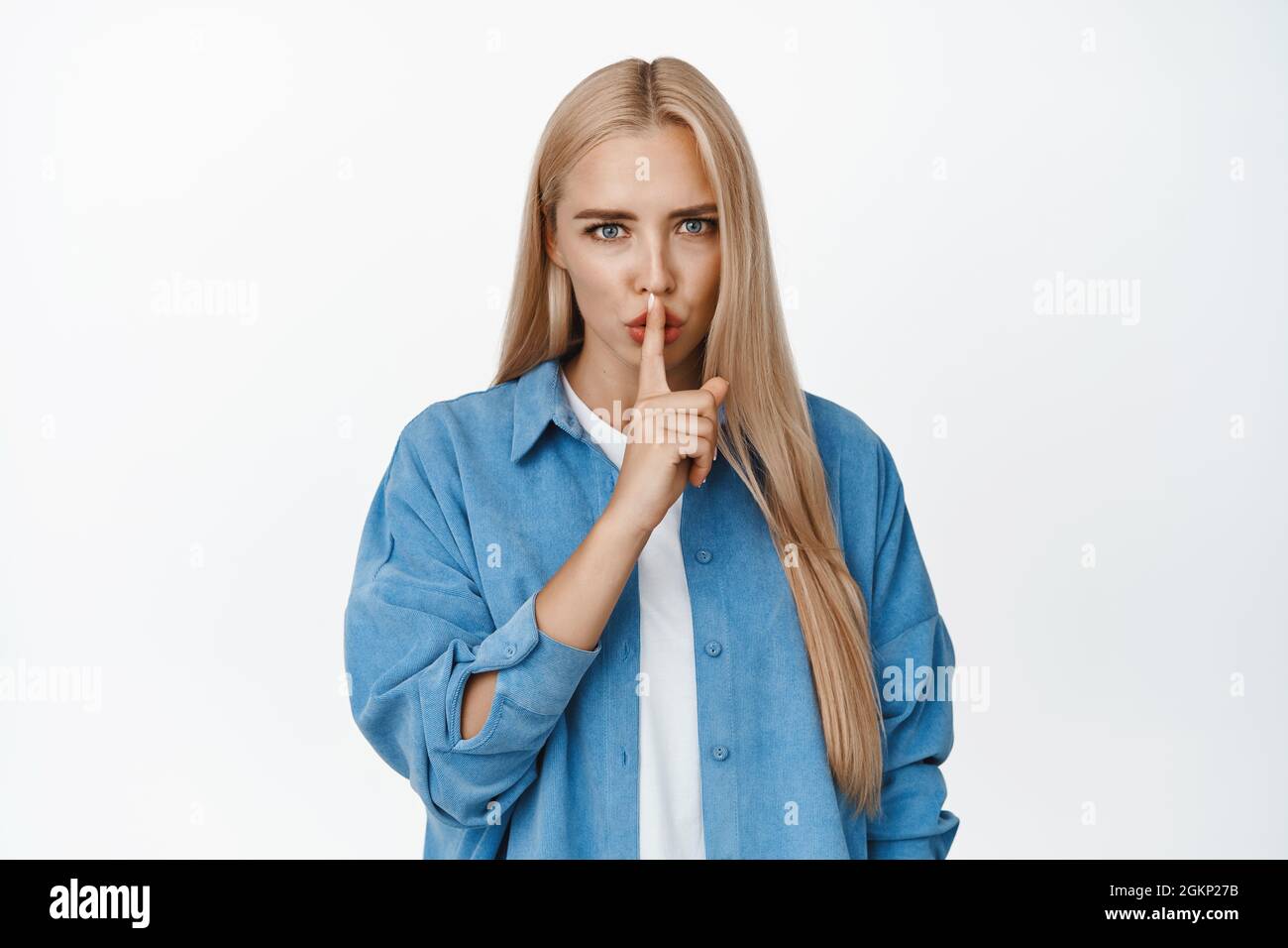 Angry blond woman shush, make shhh sound and look disappointed, telling to  be quiet, silence please, shut up gesture, standing over white background  Stock Photo - Alamy