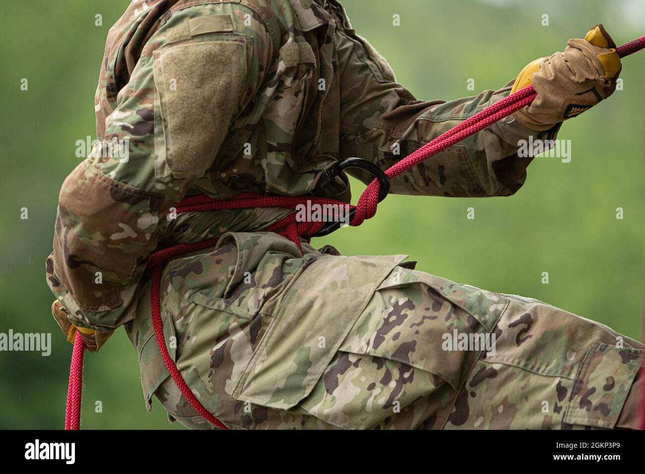 To rappel, a rope passes through a locking carabiner which, whien