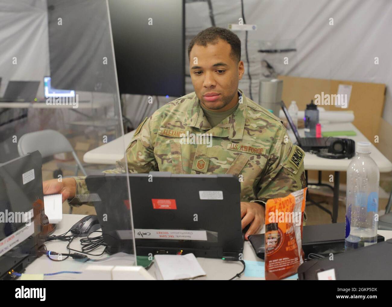 A U.S. Air Force master sergeant. works at his computer during the ...