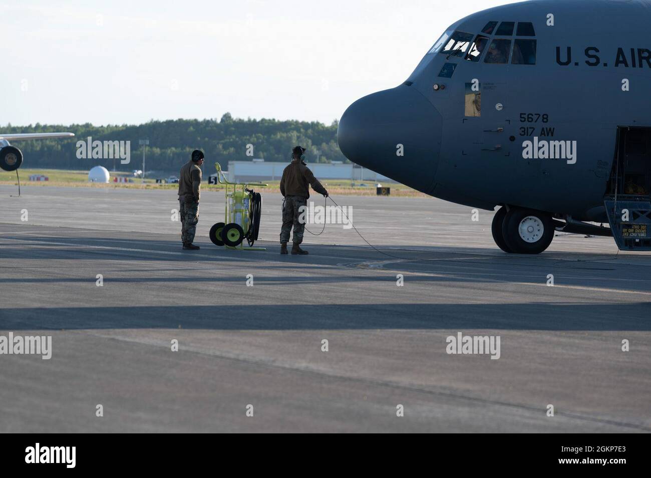 U.S. Air Force Senior Airman Rigoberto Villanueva and Airman 1st Class Jake Jardina perform pre-flight inspections during RED FLAG-Alaska 21-2 at Joint Base Elmendorf-Richardson, Alaska, June 11, 2021. Approximately 1,500 service members are expected to fly, maintain and support more than 100 aircraft from more than 100 units during this iteration of the exercise. Villanueva and Jardina are both C-130J Super Hercules crew chief  assigned to the 317th Maintenance Squadron, Dyess Air Force Base, Texas. Stock Photo