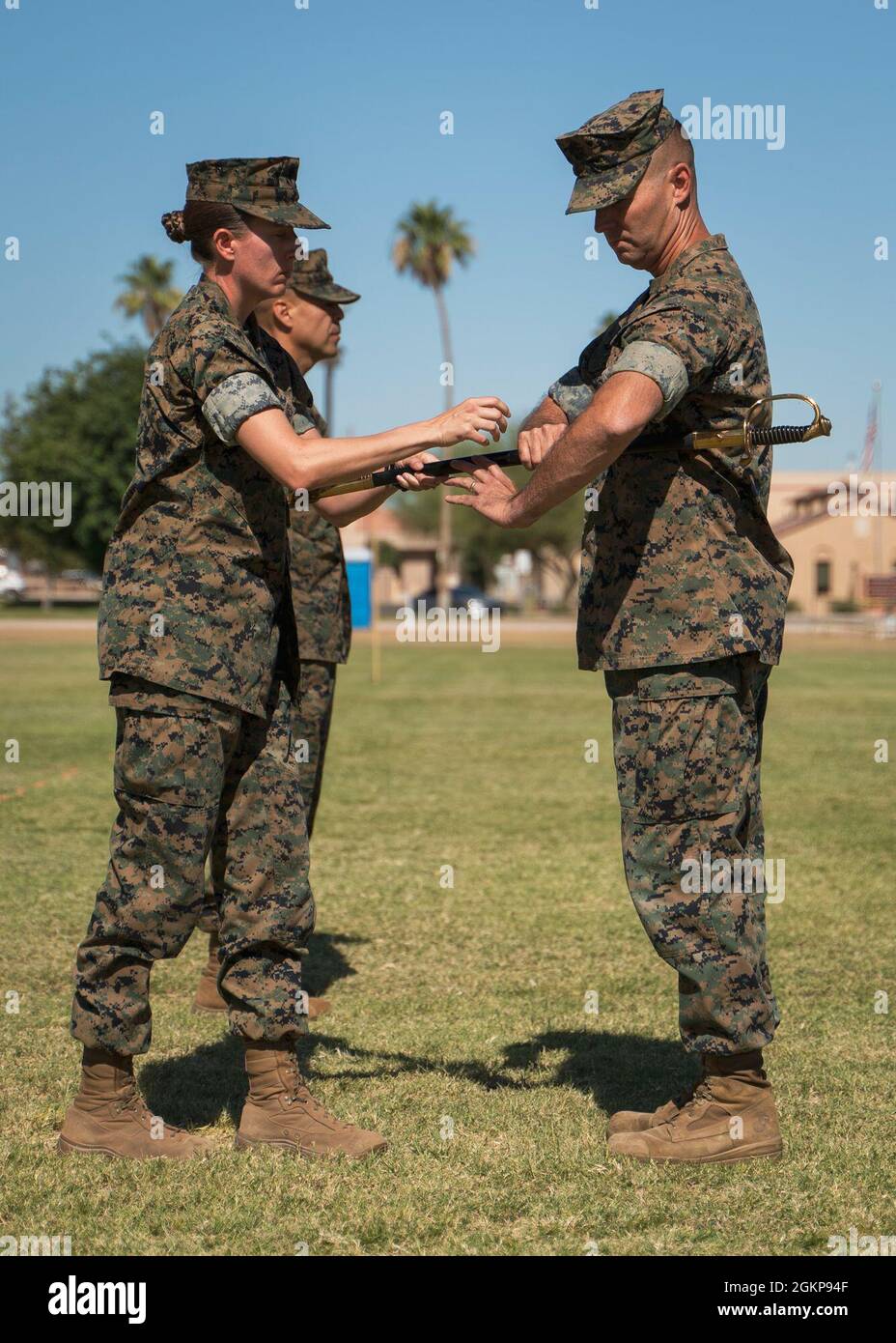 U.S. Marine Corps Lt. Col. Andrea Goeman passes the sword to Master Gunnery Sgt. Leon Harpel on Marine Corps Air Station Yuma, Ariz., June 11, 2021. The passing of the sword symbolizes the relief of duty from Sgt Maj. George Hernandez. Stock Photo
