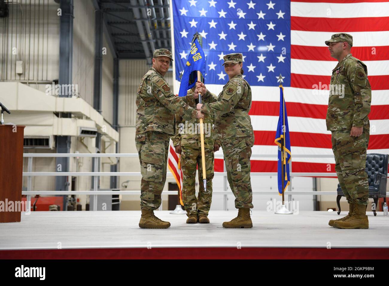 Col. Jason Dillon, 319th Operations Group commander, passes the guidon to Lt. Col. Susan Martin, 348th Reconnaissance Squadron incoming commander, the Legion of Merit during the 348 RS change of command ceremony at Grand Forks Air Force Base, N.D., June 11, 2021. The 348 RS is a squadron operating under the 319 OG. Stock Photo