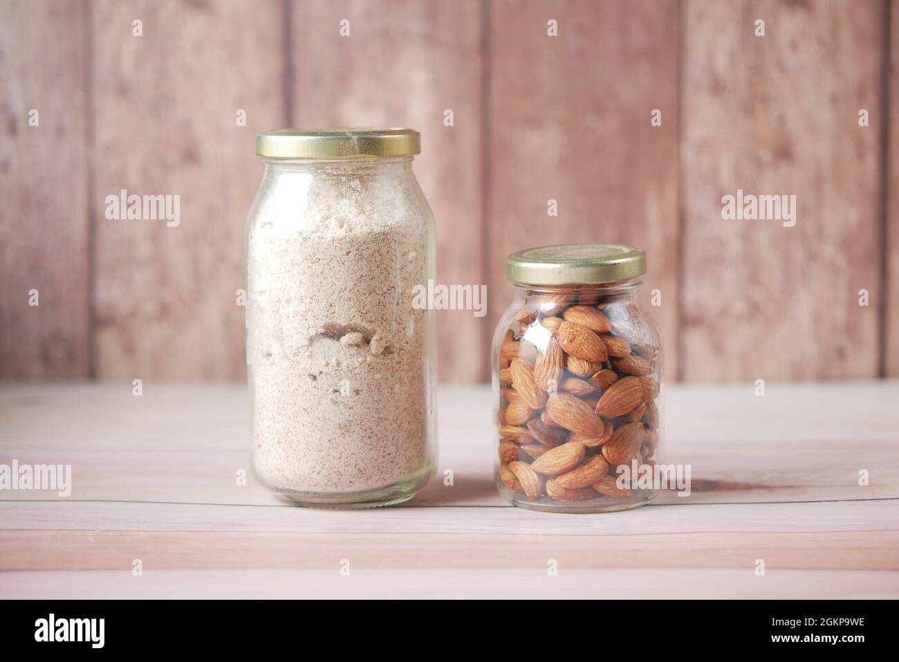 almond powder and almond in a jar on table Stock Photo - Alamy
