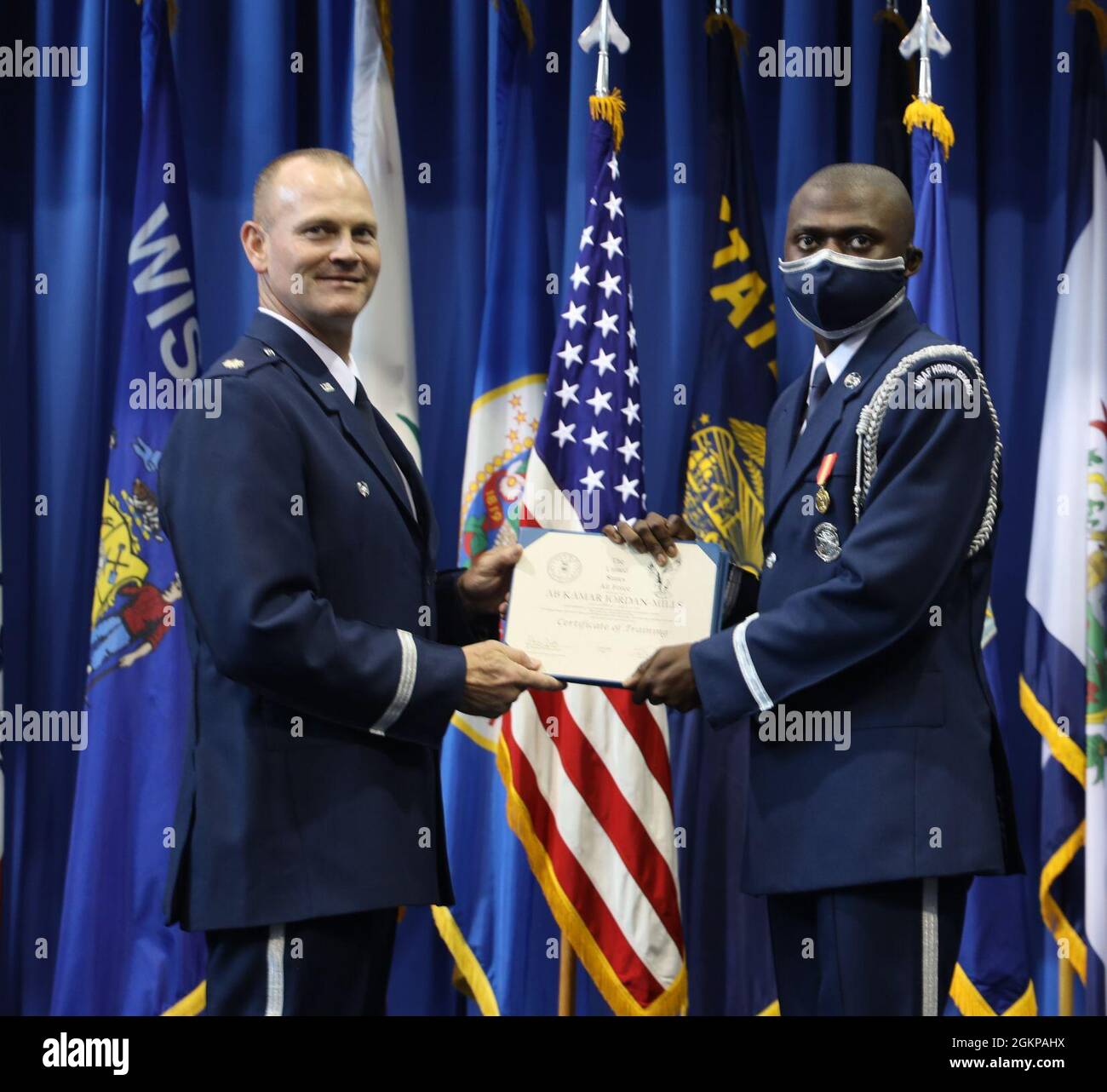 Lt. Col. Jason Woodruff, commander of the United States Air Force Honor Guard, presented graduation certificates to the new graduates of the United States Air Force Honor Guard at Joint Base Anacostia-Bolling, Washington, D.C, June 11, 2021. Airman Basic Kamar Jordan Mills received his graduation certificate for completing the eight-week training. Stock Photo