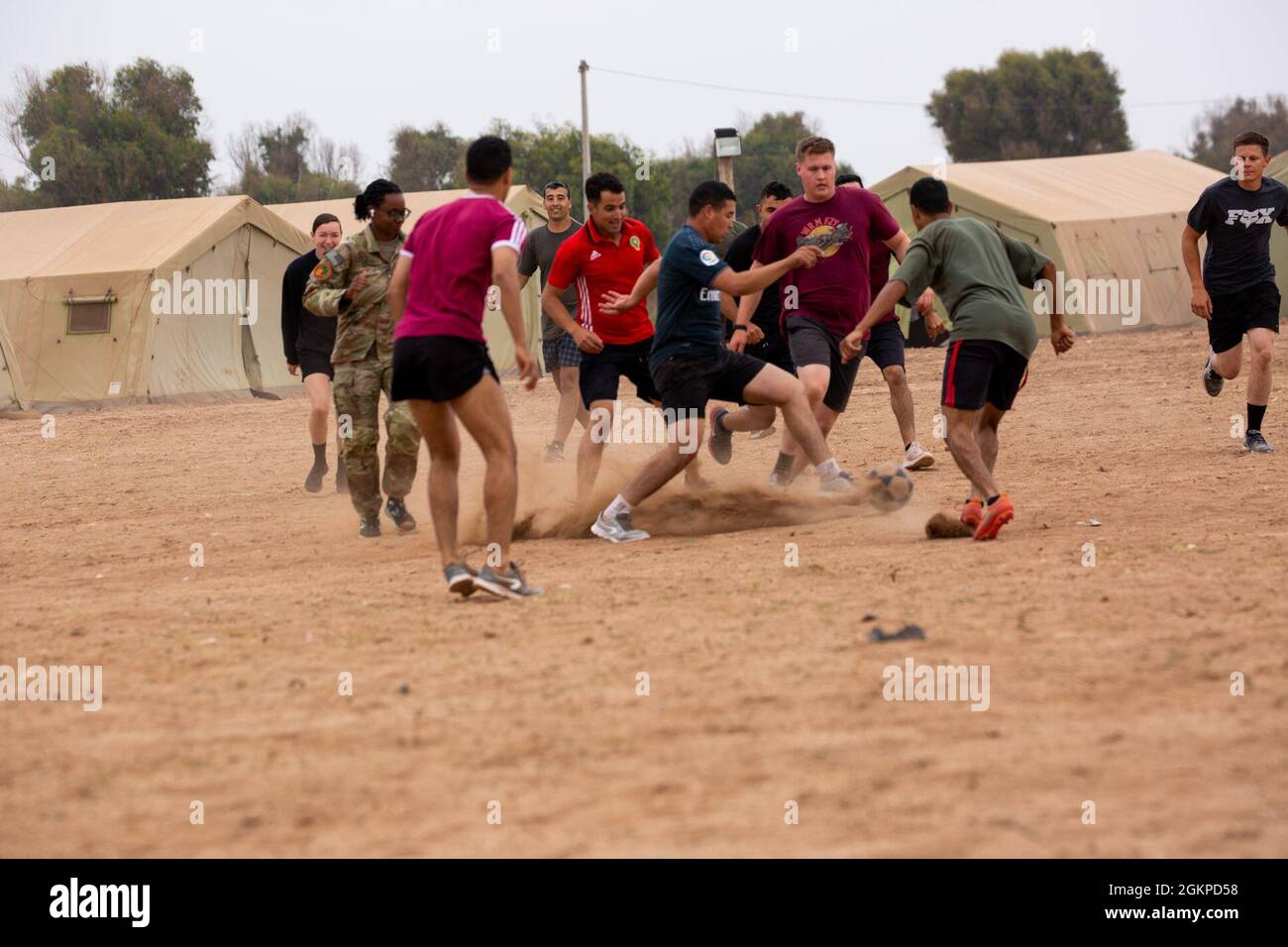 Unites States soldiers from the 19th Special Forces Group, 551st Military Police Company, 716th Military Police Battalion and Royale Moroccan Forces play soccer together to take a break from the Africa Lion 21 Exercise Training at Camp Tifnit on June 12, 2021. African Lion 2021 is U.S. Africa Command's largest, premier, joint, annual exercise hosted by Morocco, Tunisia and Senegal, 7-18 June. More than 7,000 participants from nine nations and NATO train together with a focus on enhancing readiness for U.S. and partner nation forces. AL21 is a multi-domain, multi-component, and multinational ex Stock Photo