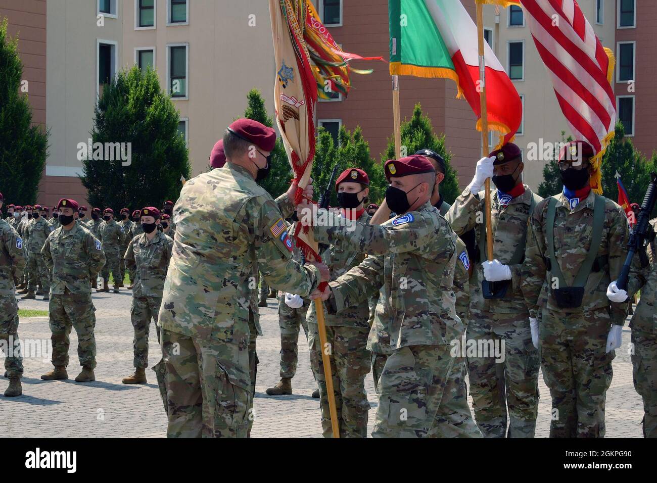 U.S. Army Lt. Col. Nathan A. Strohm, outgoing commander, 173rd Brigade Support Battalion, 173rd Airborne Brigade, passes the colors to Col. Kenneth J. Burgess, commander of the 173rd Airborne Brigade during change of command ceremony under Covid-19 prevention condition at Caserma Del Din, Vicenza, Italy June 14, 2021. The 173rd Airborne Brigade is the U.S. Army Contingency Response Force in Europe, capable of projecting ready forces anywhere in the U.S. European, Africa or Central Commands' areas of responsibility. Stock Photo
