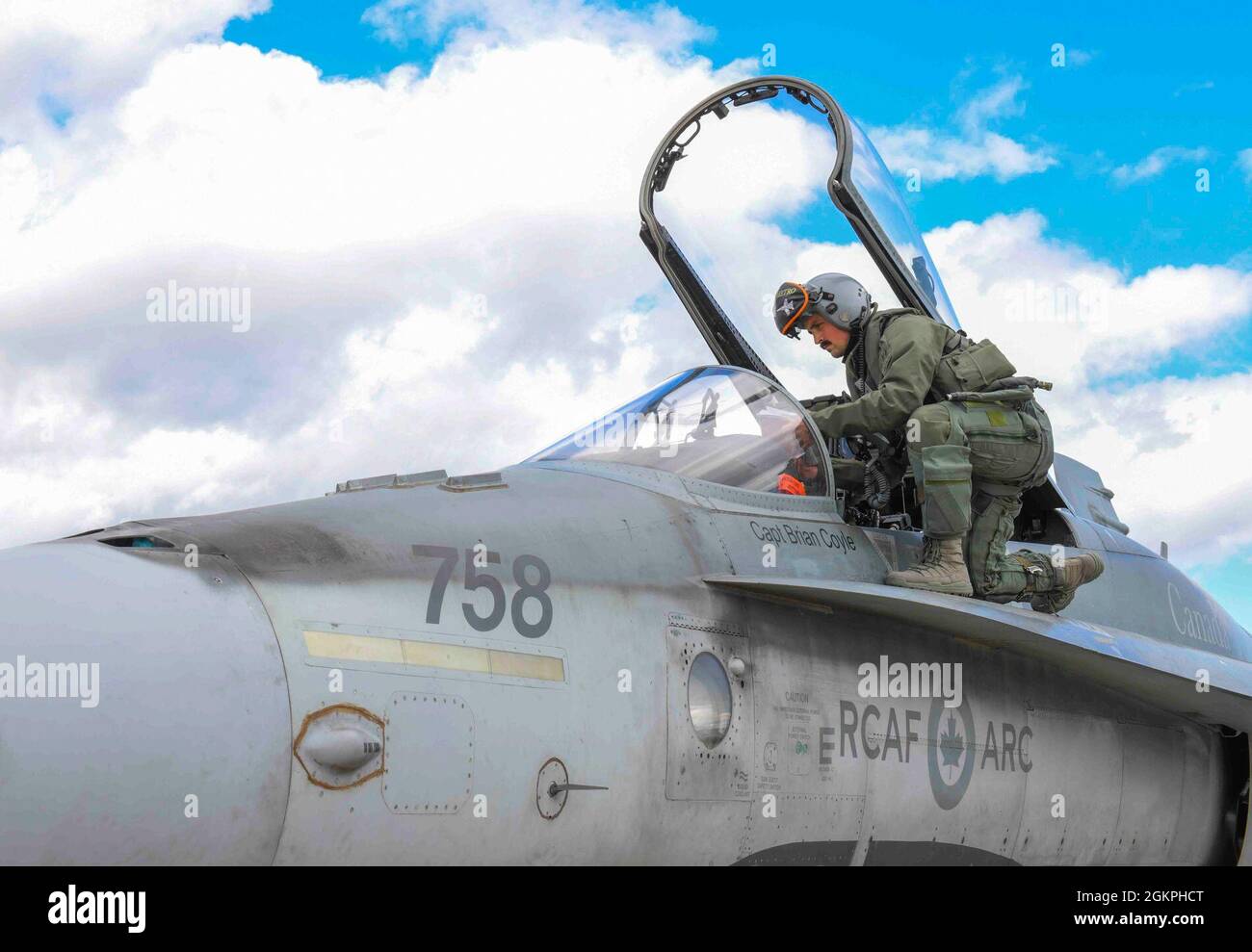 A Royal Canadian Air Force pilot from the 433rd Tactical Fighter Squadron  climbs into the seat of an CF-18 Hornet to prepare for takeoff during  exercise Amalgam Dart 21-01 at Goose Bay,