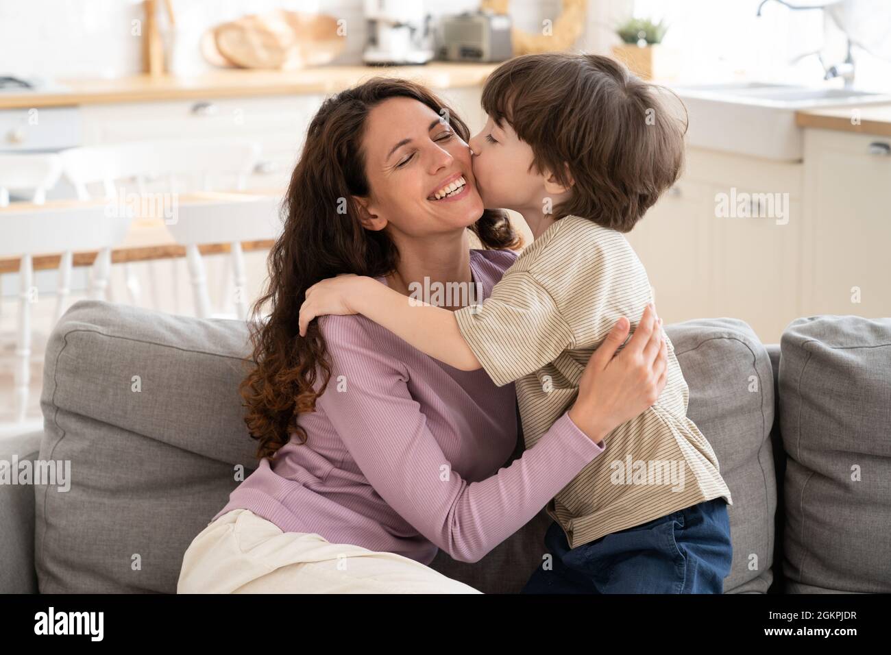 Son boy give mom kiss in cheek embrace single parent mum on mother ...