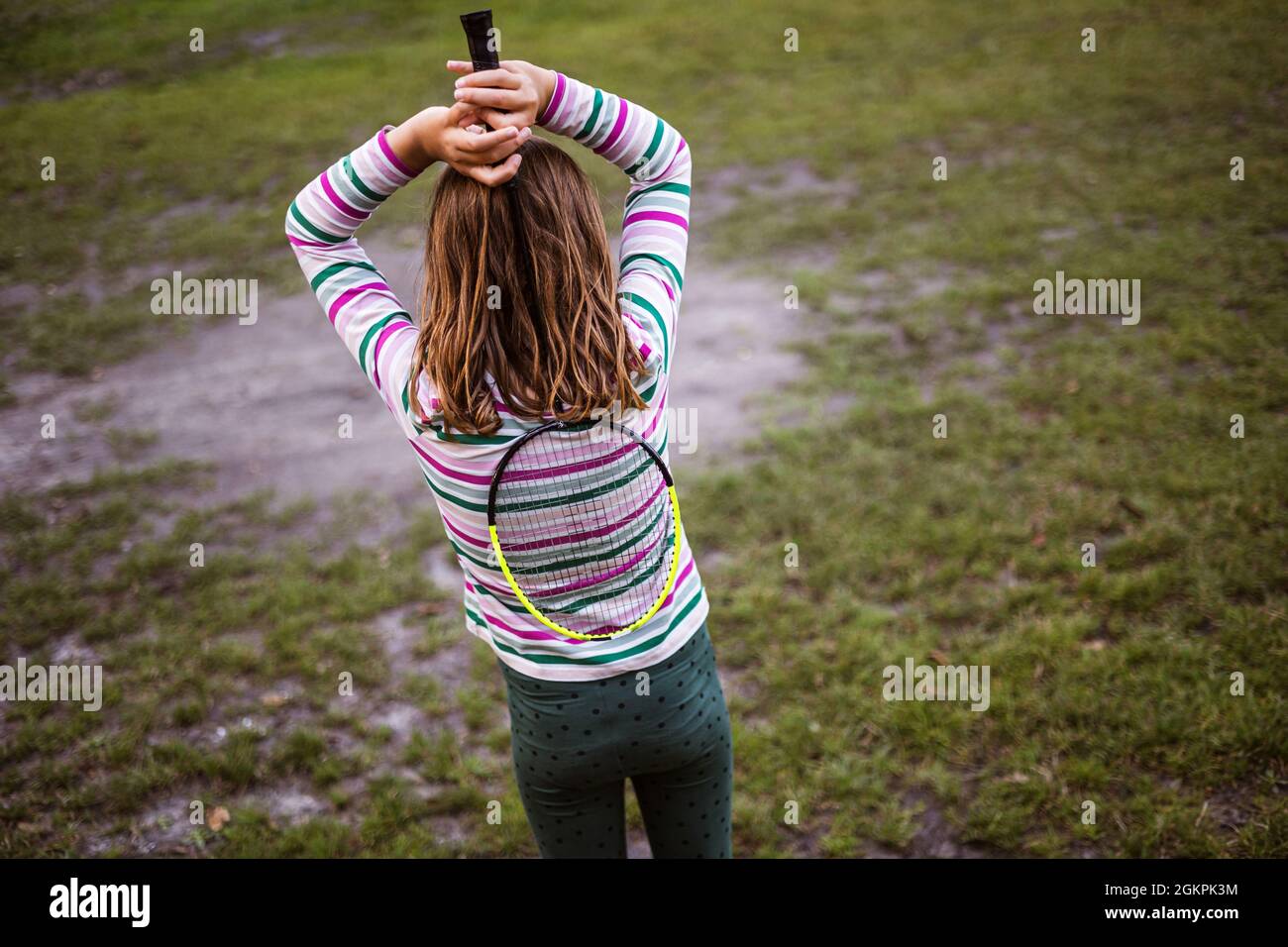 Girl with badminton racket, rear view Stock Photo