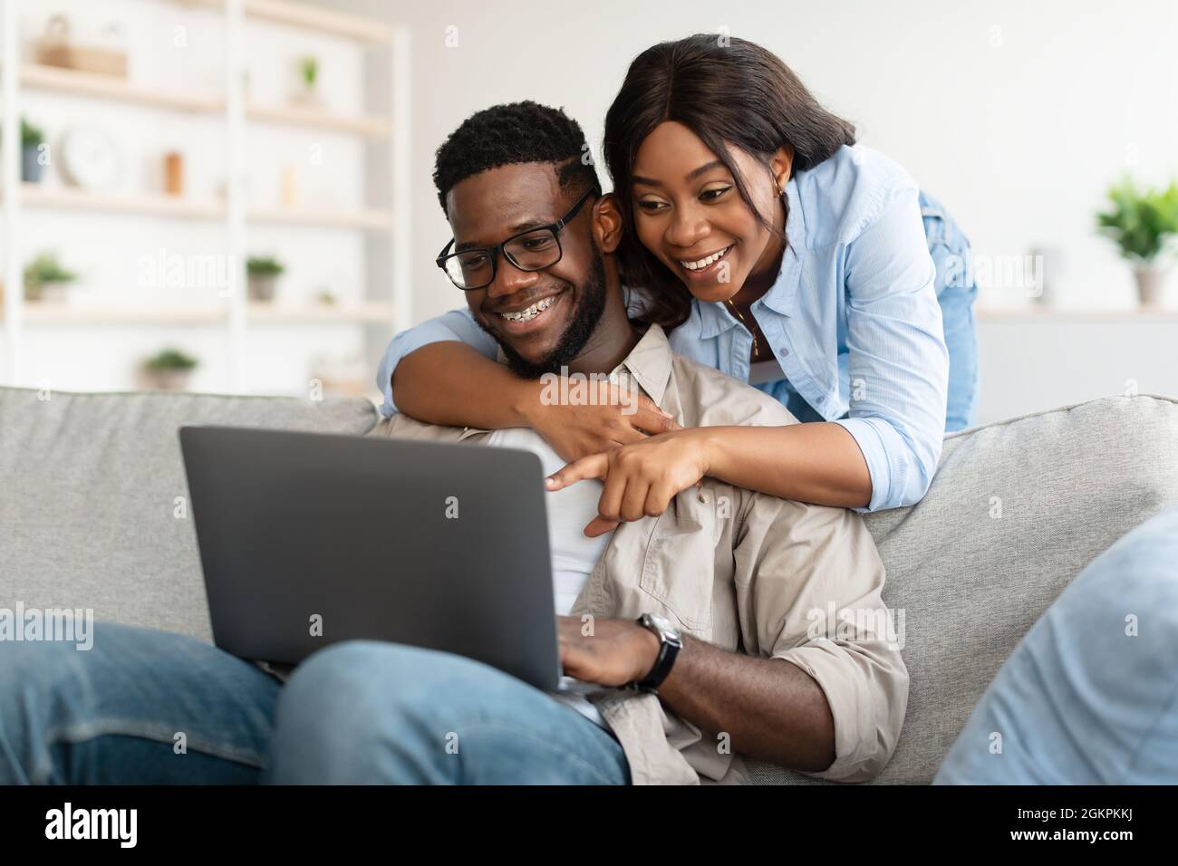 Portrait of African American couple using computer pointing at screen ...