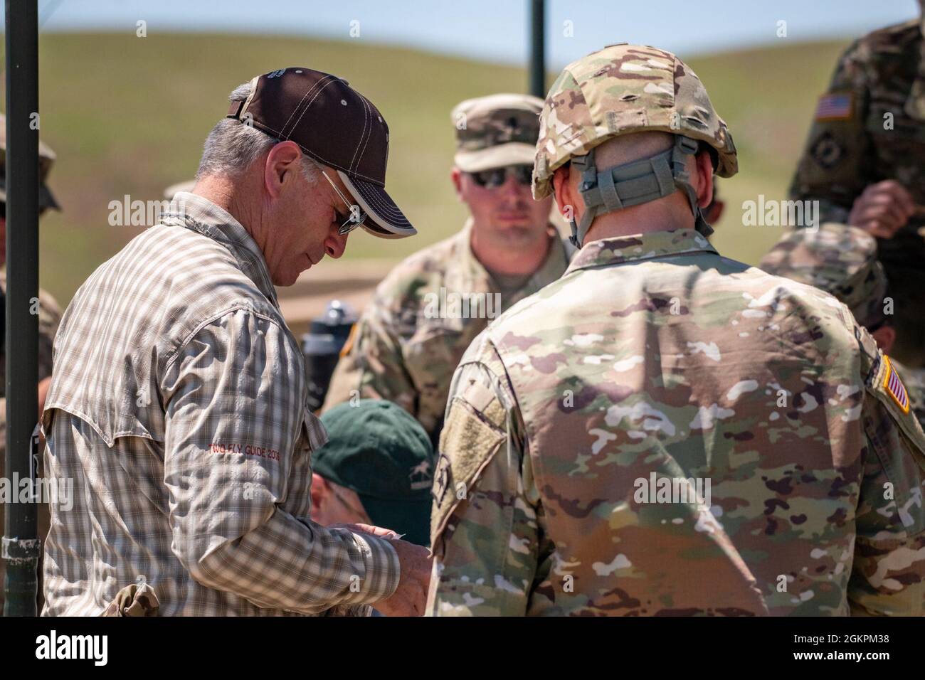 Wyoming Gov. Mark Gordon and his wife, Jennie, Sen. Dan Dockstader, and Rep. Donald Burkhardt Jr., spend the day with Wyoming Army National Guard Soldiers from the 2nd Battalion, 300th Field Artillery Regiment at Camp Guernsey Joint Training Center, Guernsey, Wyo., June 14, 2021.    During the trip, they learned about the unit, watched and fired a High Mobility Artillery Rocket System (HIMARS), and got to know Soldiers during lunch over a meal ready-to-eat (MRE). Stock Photo