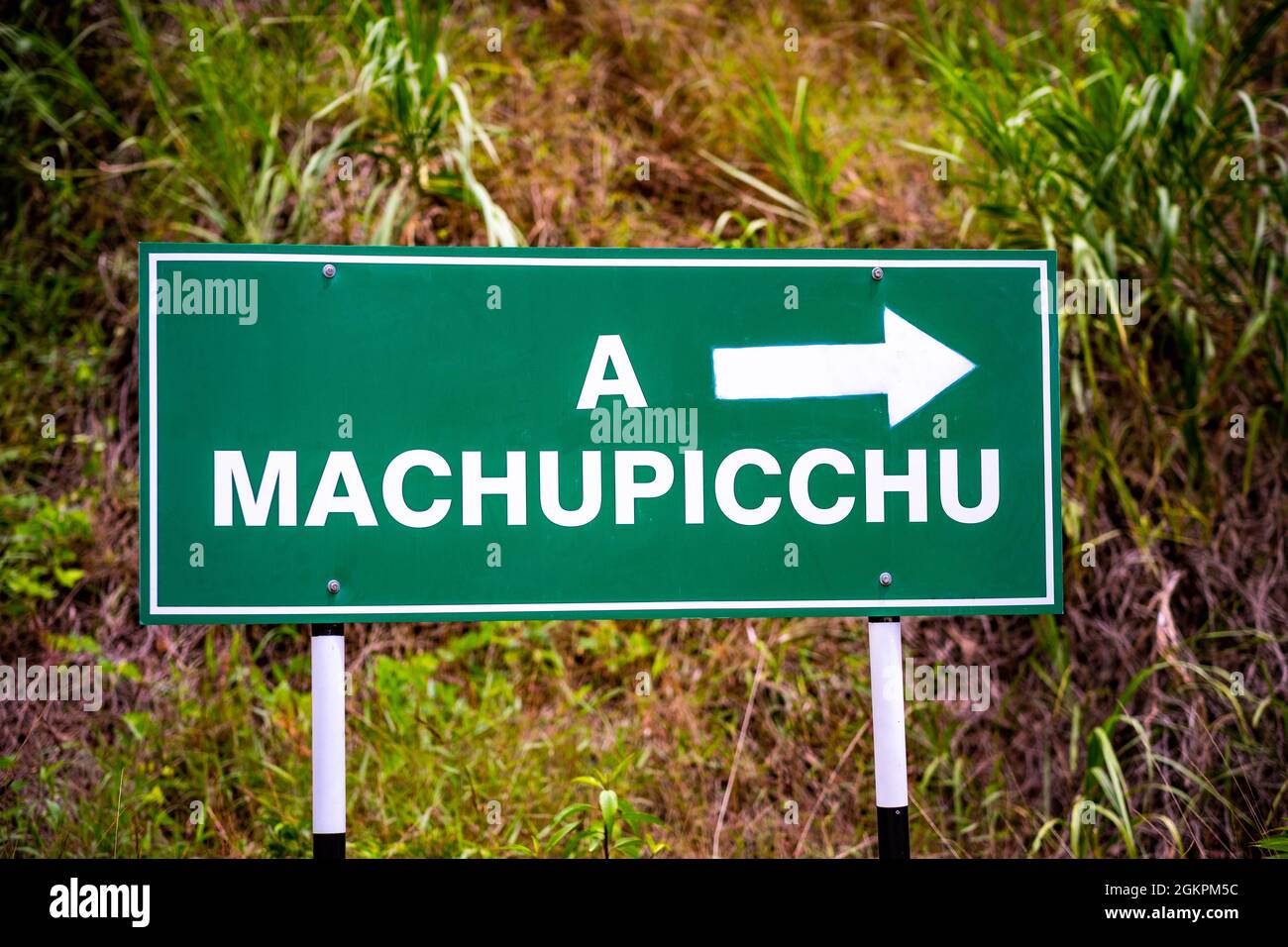 Green pointing sign to Machupicchu Stock Photo